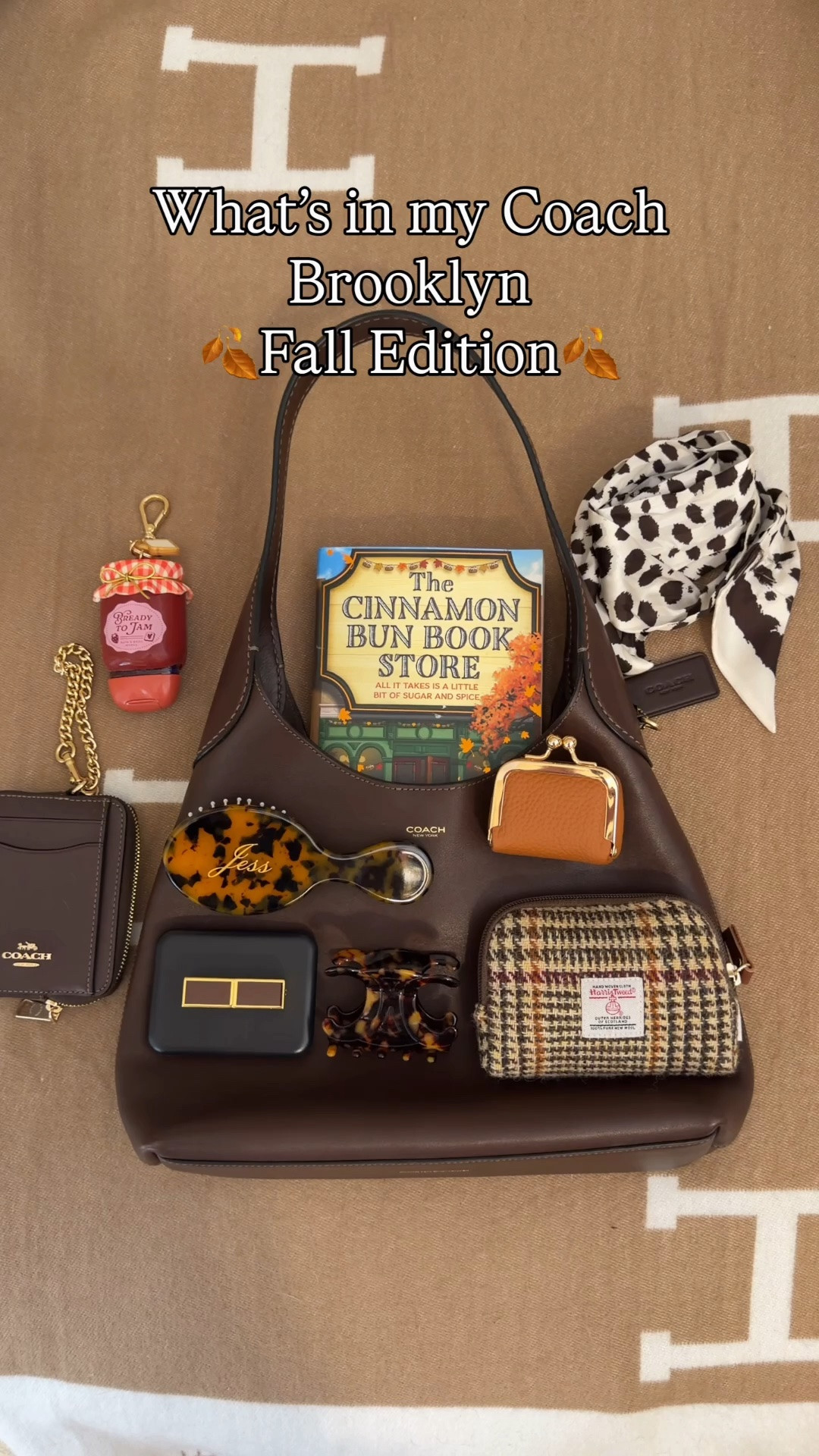 What’s in my bag 🍁 Comment SHOP & I’ll dm you the links 🍂

What fits in the Brooklyn 28
Cinnamon Bun Book Store book
Reusable sticky lint roller ball
Harris tweed pouch
Bath and body works pumpkin cold foam lip oil
KayAli mini perfume
Tom ford mini lipstick in Casablanca
Mini cleaning wipes
Mini jewelry Kisslock holder
Custom mini hairbrush
Coach outlet spotted scarf
Bath and body works jam hand sanitizer holder bag charm 
Coach chain charm and pumpkin bag charm from Amazon 
Coach Brooklyn 28 packing video 
Fall packing, fall bag, fall bags