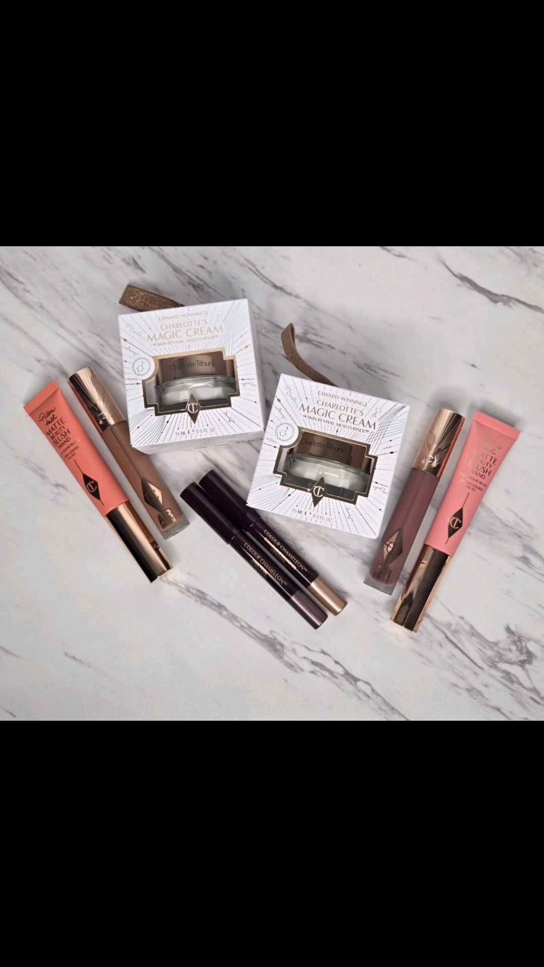 During the holidays I also picked up these @charlottetilbury Charlotte's Beauty Trinkets Mystery Boxes. The mystery boxes came in 2 options Pink or Peach and came with four beauty products. Three of them were full sized and one was deluxe sized. I saw some videos on TikTok of what the items were and decided to order both boxes. The boxes were $66.00 each. Considering the cost of Charlotte Tilbury products this was a great price. My first order was accidentally shipped to my old house and could not be re-routed so I had to wait until they were back in stock to re-order. I believe when the first set of mystery boxes went out of stock they restocked them with new items because I did not receive the items that I saw in other people's videos. That was disappointing because the one item that I was really excited to get were the Eyes to Mesmerize potted cream eyeshadows. These were not in my boxes. My boxes contained a full sized Pillow Talk Matte Beauty Blush Wand (Pink Pop and Peach Pop) , a full sized Colour Chameleon Eyeshadow Crayon (Champagne Diamonds and Dark Pearl), a full sized Air Brush Flawless Lip Blur (Pillow Talk Medium Blur and Nude Blur), and a deluxe sized sample of Charlotte's Magic Cream. While I do think these boxes were a great value I wish I received the first set of mystery boxes that went out. I want to say for the Pink mystery box the original Pillow Talk Lip Blur was sent which I would have preferred over the Pillow Talk Medium which is darker on me. It is still a pretty color just darker than what I would have liked. It actually looks brownish in my swatches but it looks more dark mauve on my lips. The Nude Blur is really orange on be so unless I make it work with a darker brown liner then I most likely won't use it and just pass it on. I also really wanted more of the Eyes to Mesmerize Shadows. The crayons are nice though and both colors work for me. I will most likely use them for when I am wearing minimal makeup and just want a quick wash of color on the lids. I don't use cream or liquid blushes really ever but I will say these Blush Wands apply pretty easily. However, I have only used them with minimal makeup and not a full face of foundation. I normally would gravitate towards the peach but it is very bright. A little definitely goes a