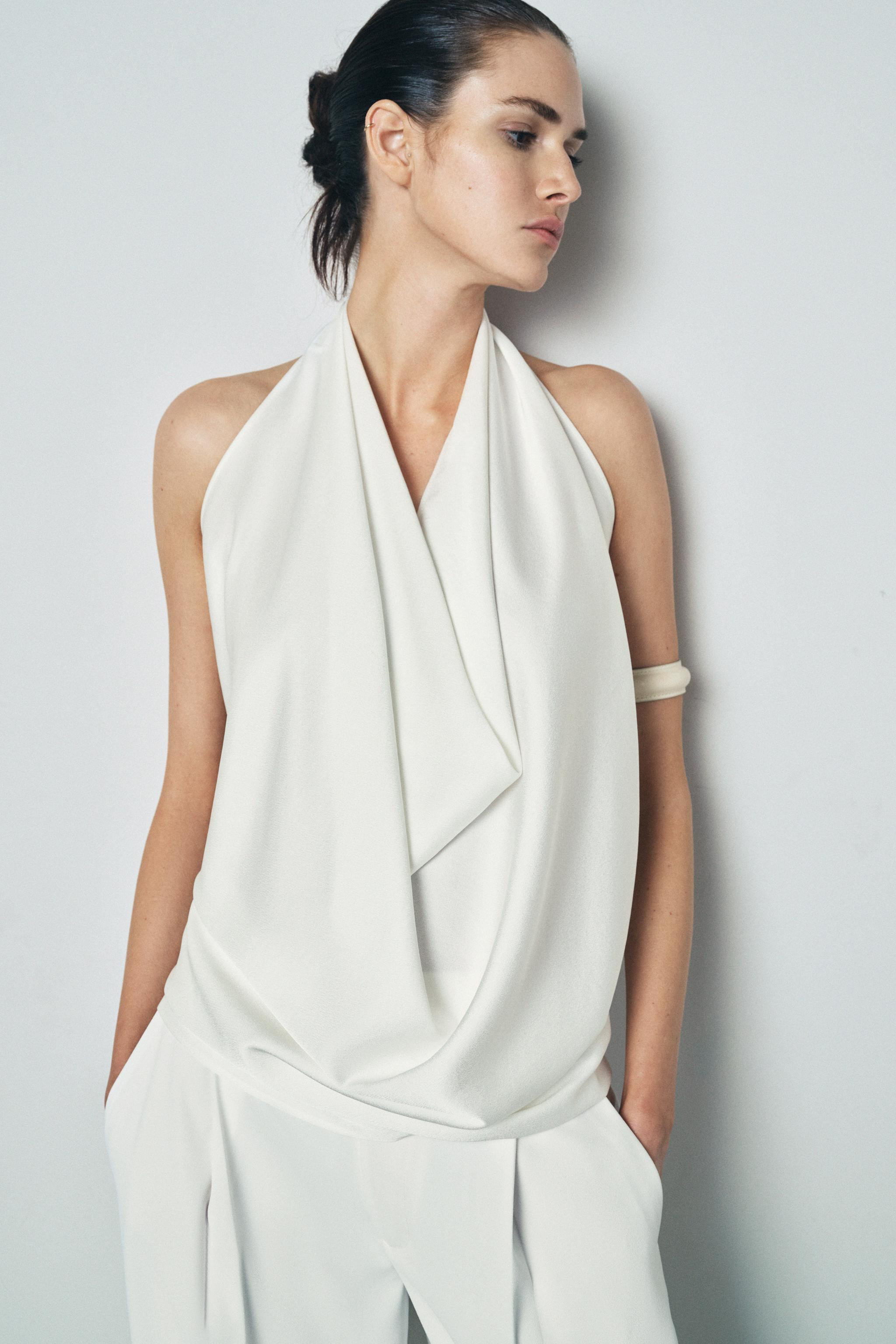 ZARA WOMAN COLLECTIONFlowy halter neck top with open shoulders. Open back detail. Rounded hem. Bu... | Zara US