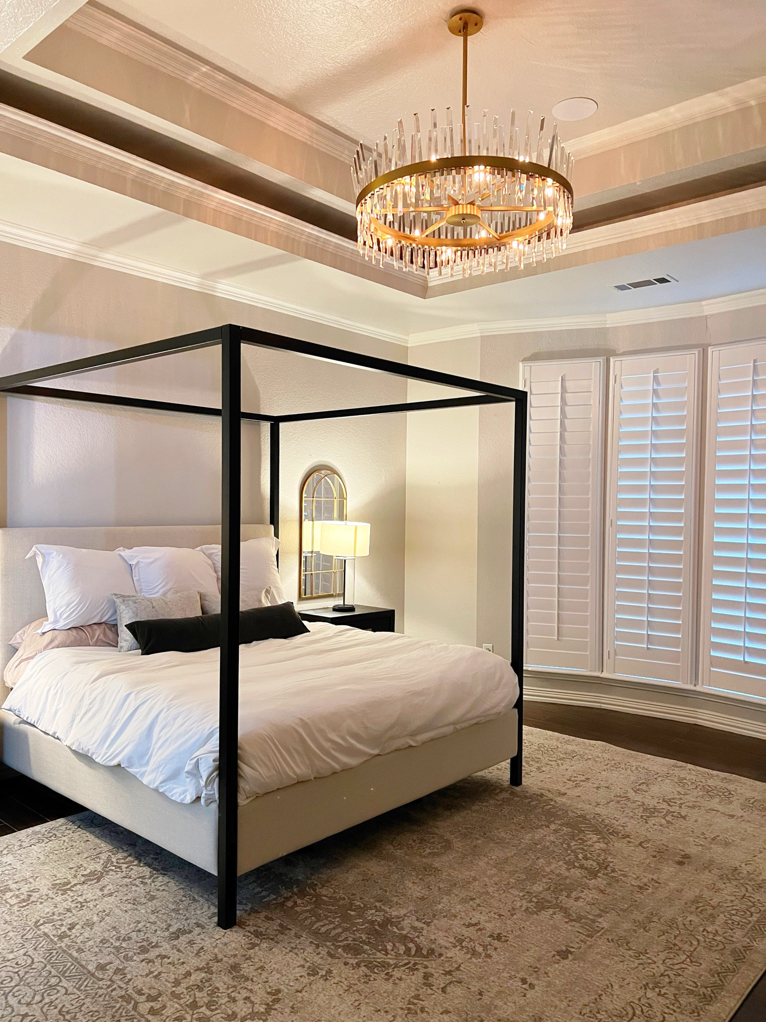 Primary bedroom. Master bedroom. Canopy bed. Pottery barn. Area rug. Modern chandelier. Bedroom furniture. Nightstand. Lamp  

#LTKFind #LTKhome #LTKfamily