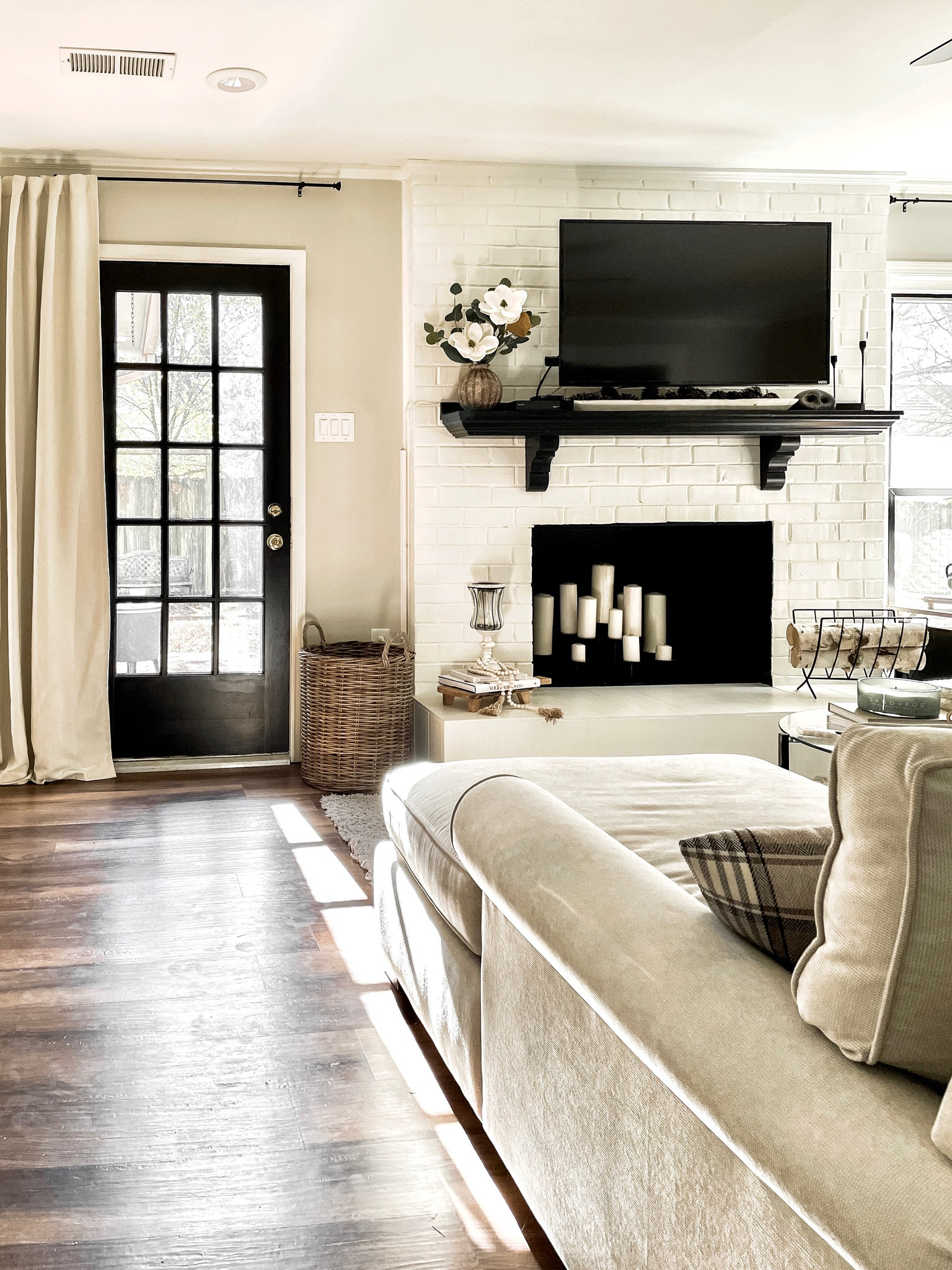 Neutral living room aesthetic 
Gray walls
Black doors
Woven basket
Pinch pleat curtains 


#LTKstyletip #LTKSeasonal #LTKhome