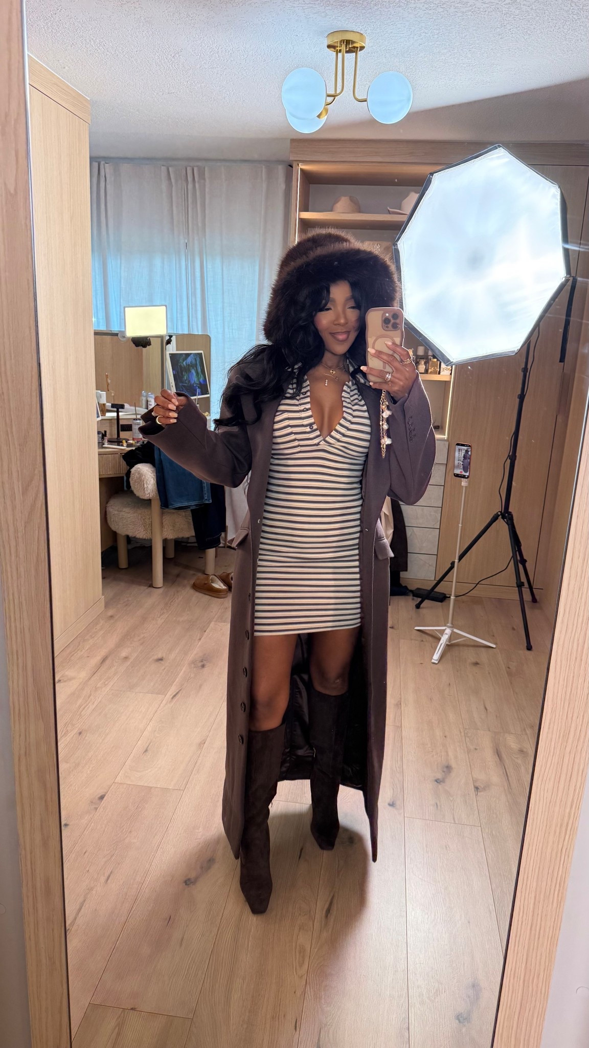 Chic layers with a cozy-cool edge 🤎 This striped mini dress paired with a long brown coat and knee-high boots creates an effortlessly styled look that feels elevated yet wearable. The fur hat adds a luxe winter touch that pulls everything together.

Perfect for brunch dates, winter outings, city strolls, and casual holiday plans.

📏 Sizing:
Dress: Small  
Coat: Small  
Boots: True to size  
Measurements: 5’4” • 138 lbs • 34D • 27” waist • 40” hips

This look features a striped mini dress outfit, brown coat styling, winter dress outfits, knee-high boots looks, cozy chic fashion, and elevated cold-weather style.

Tap to get details and shop everything linked.  
Follow me on Instagram and YouTube @kirasfashionfinds