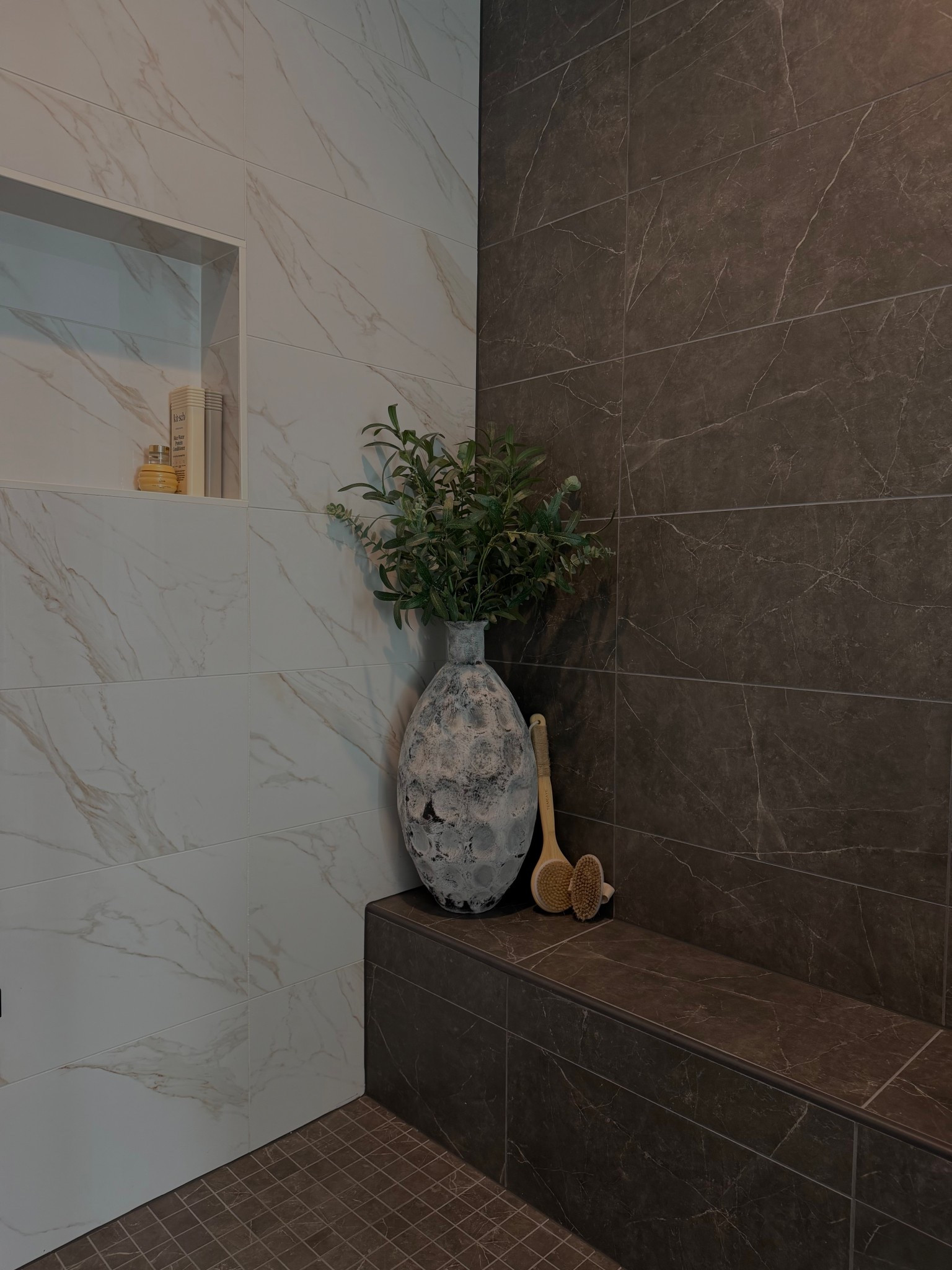 Primary shower - balanced & moody vibes 🤤 

✨Here’s what we used: 

• Shower Pan Floor: 
Emser Sterlina II Asphalt Matte - 2” x 2” Mosaic

• Shower Walls: 
Emser Nobleza 12” x 24” Lugo Polished

• Bench Wall & Bench: 
Emser Sterlina II 12” x 24” Asphalt Matte

#homebuilding #customhomebuildideas #bathroomrenovations

#LTKHome #LTKdayinmylife