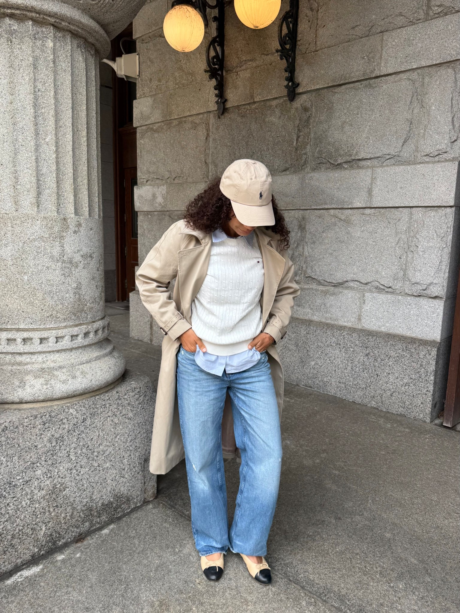 Casual chic spring outfit with a trench coat, jeans, cap toe ballet flats, Ralph Lauren baseball cap, sweater, and button up. 

#LTKootd