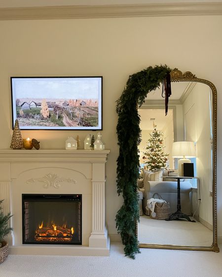 Cozy up the bedroom with an electric fireplace and adding garland to the mirror.

#LTKhome #LTKSeasonal #LTKHoliday
