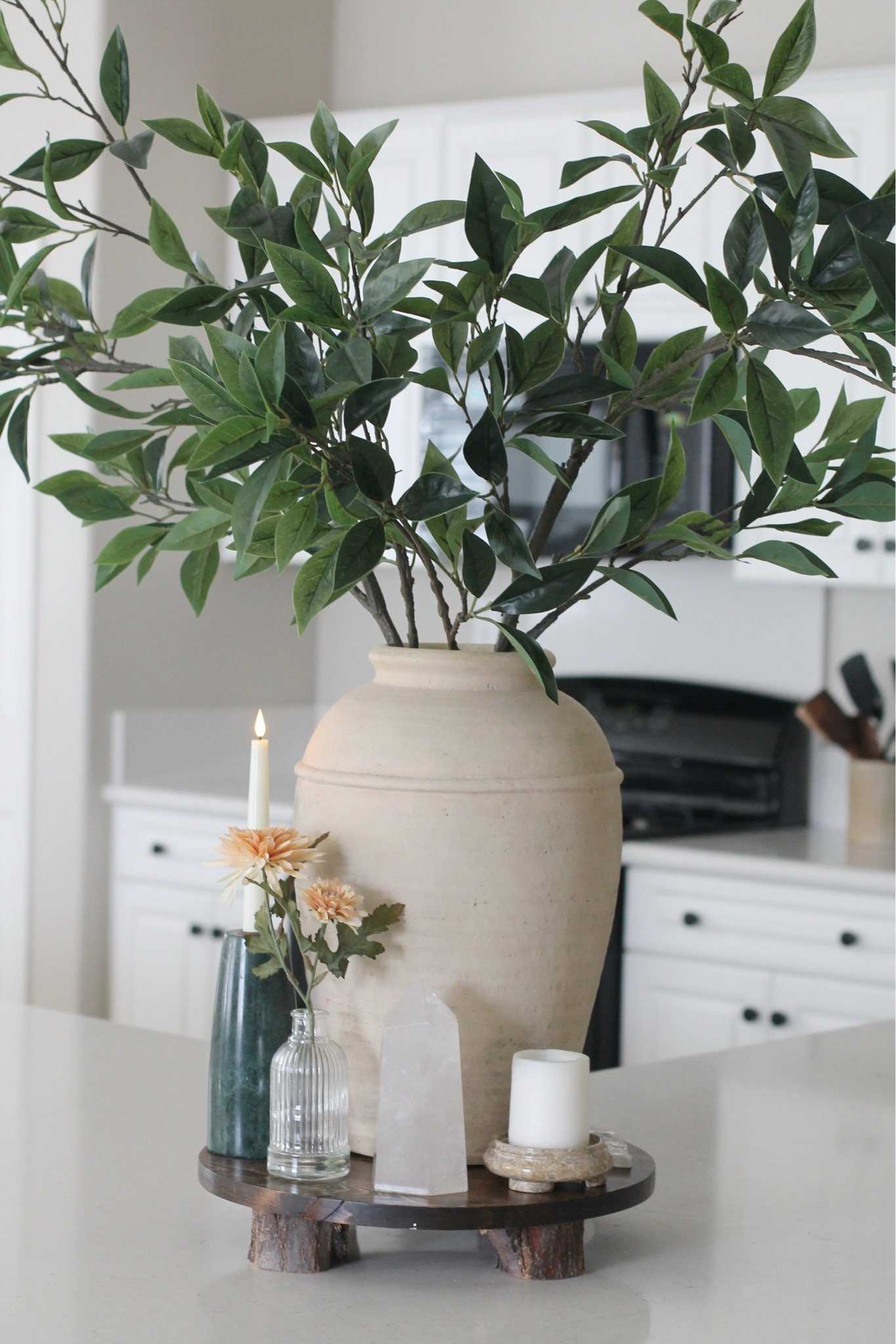 Spring kitchen island decorating
Beige vase, green stems from Pottery Barn
Orange flowers from Target
Green marble candlestick holder 
Quartz Crystal and candles
Wooden stand 
White kitchen 
Organic modern home decor 

#LTKSeasonal #LTKHome #LTKFindsUnder50