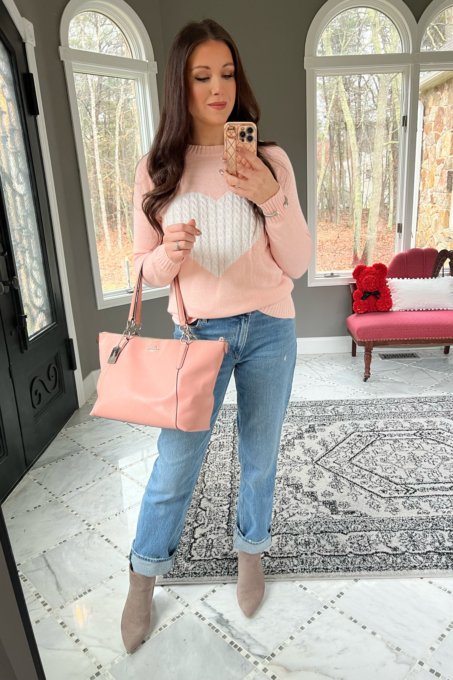 Heart sweater, Valentine’s Day outfit, Valentine’s Day sweater, pink sweater, pink sweater with hearts, pink leather tote, pink coach bag, pink designer bag, wide leg jeans, mom jeans, trendy jeans, asymmetric close jeans, ankle booties, women’s ankle boots, women’s gray boots, pink outfit, all pink everything, Valentine’s Day look 

#LTKitbag #LTKSeasonal #LTKFind