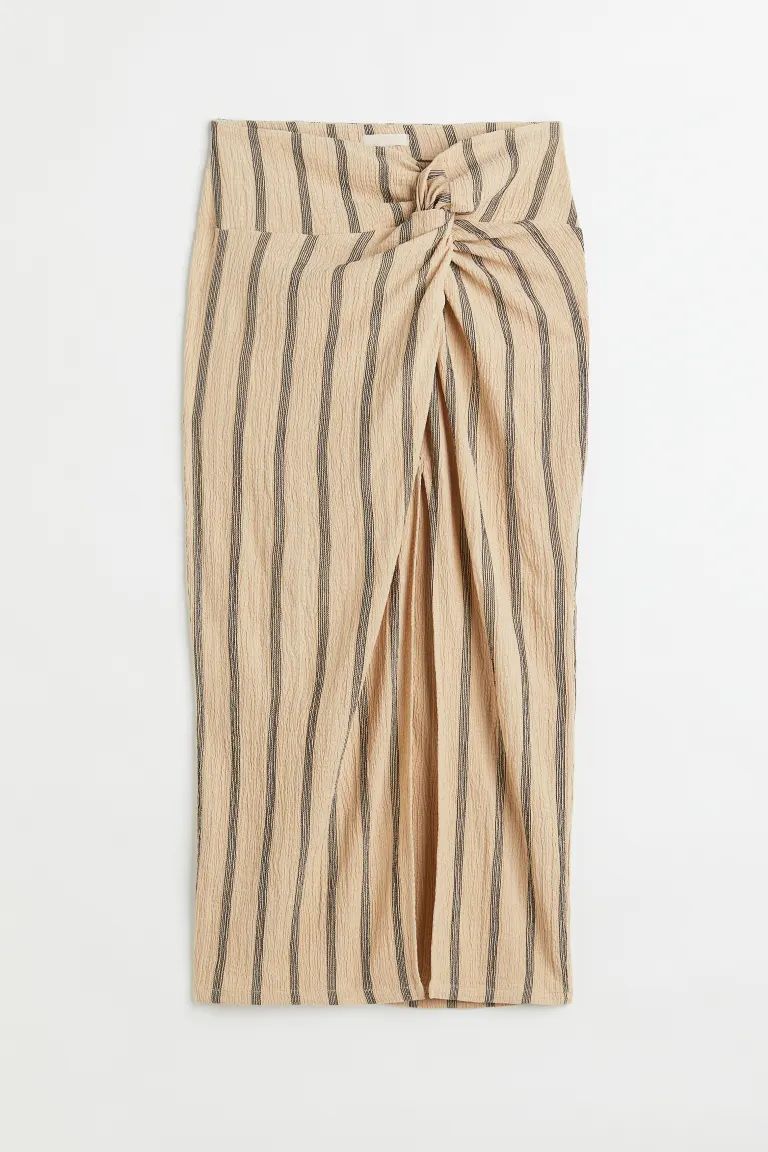 New ArrivalFitted, calf-length skirt in jersey. Wide waistband, sewn wrapover at front, and decor... | H&M (US + CA)