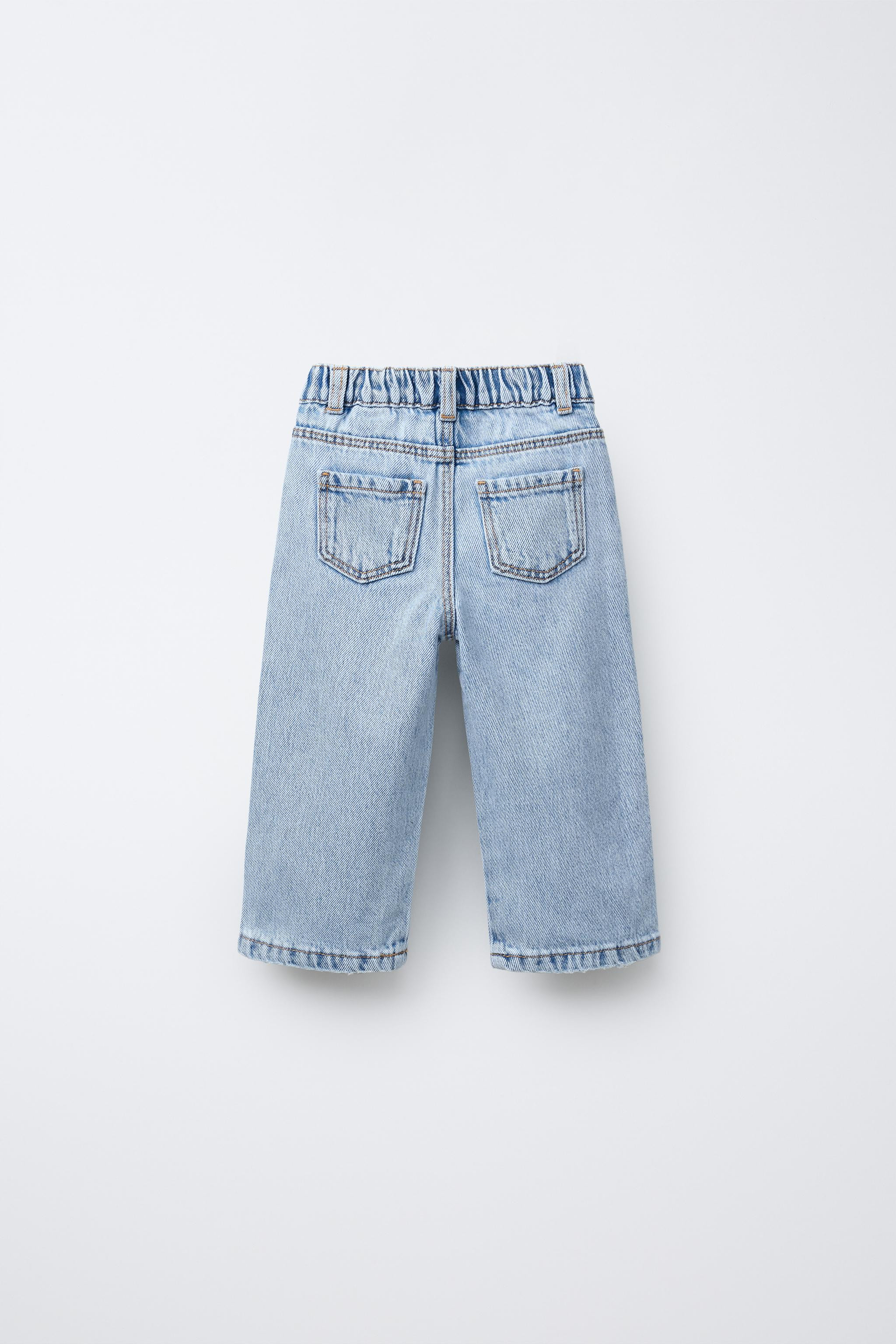 Wide leg jeans with elastic waistband and front snap button closure. Front pockets and patch pock... | Zara US