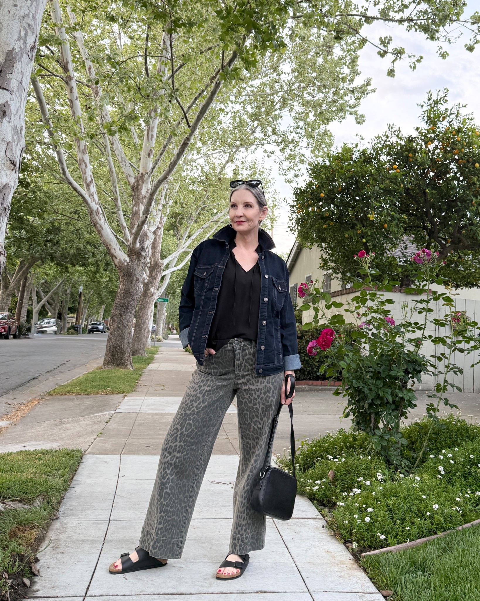 Spring outfit of the day. Mix & matching some of my favorites into a new outfit. #leopardjeans #darkdenimjacket #comfortablesandals #coolsandals #crossbodybag #springootd #midsizestyle #styleover50 
size down 1 size in jeans

#LTKOver40 #LTKMidsize #LTKootd