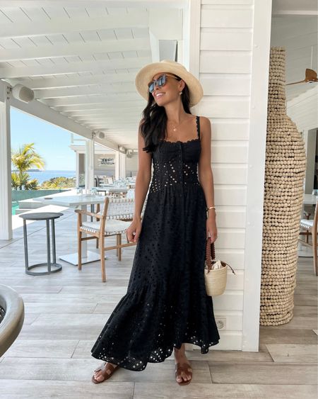 Kat Jamieson wears a black eyelet dress for spring break vacation in St. Barths with a Panama hat and straw tote. Hermes sandals, Oran sandal, lbd, sundress, midi dress, maxi dresses. 

#LTKtravel #LTKshoecrush #LTKSeasonal