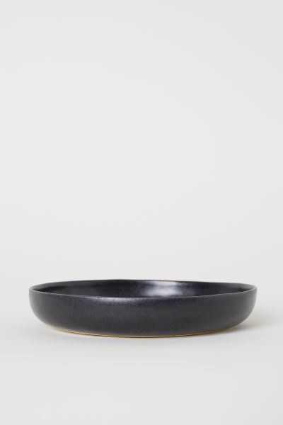 Deep plate in glazed stoneware. Height of rim 1 3/4 in. Diameter 8 1/4 in. Reactive glaze creates... | H&M (US + CA)