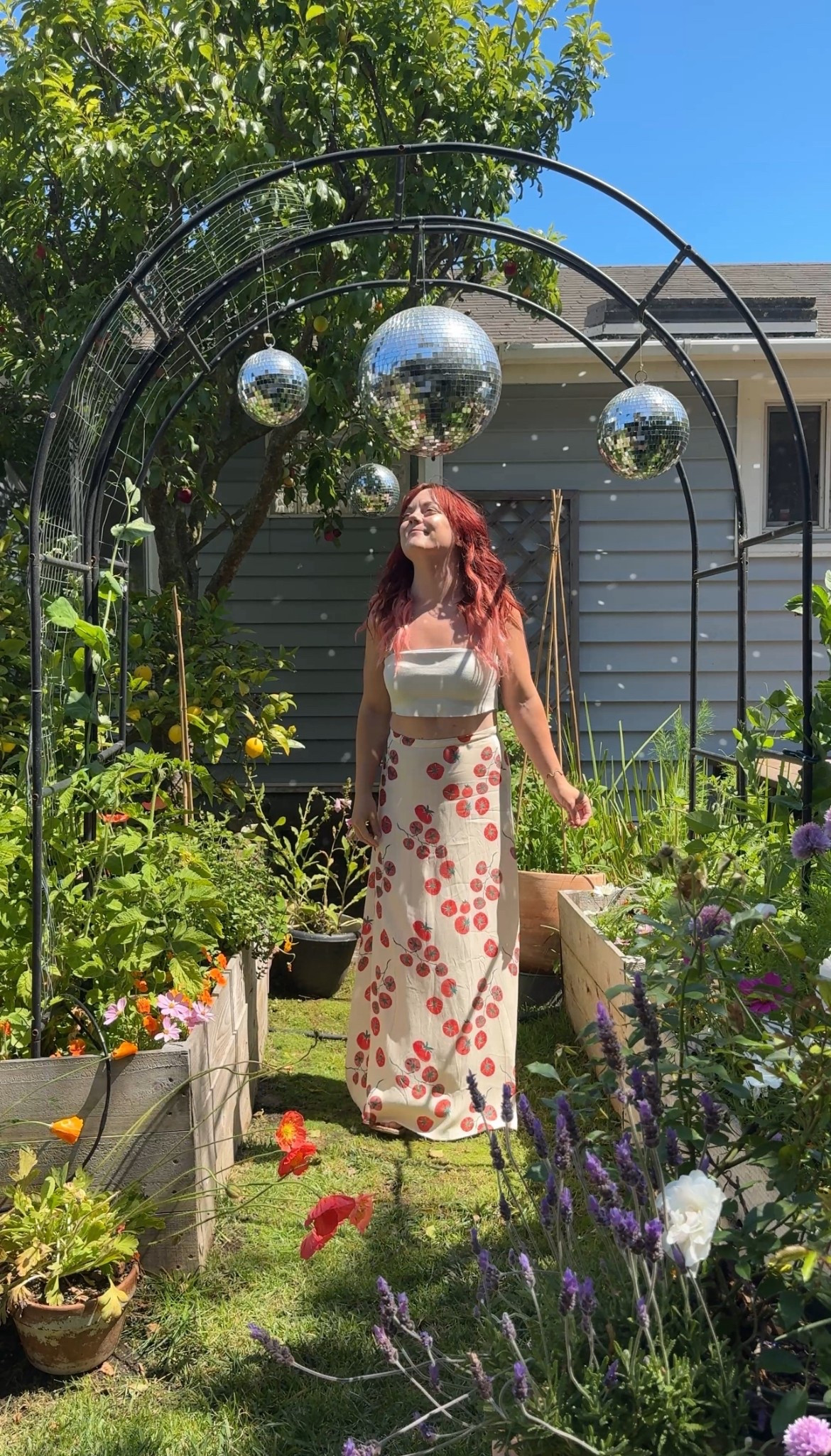 Hanging out in the disco garden 🪩 

Wearing a tomato print skirt in a garden with disco balls. 

#LTKStyleTip #LTKSeasonal