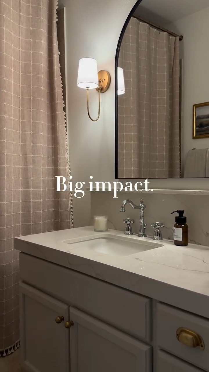 No renovating required. 
This is one of my favorite before and afters simply because every single change we made with time greatly transformed it. From changing out the shower curtain to swapping the mirror.
Start with one thing at a time and you will see how different the feel in the room is!

Comment SHOP for links to transform yours!
🥹
.
.
.
#budgetfriendlydecor #affordablehomedecor  #stylewithme #dailyreels #reelsinstagram #homeinspo #reelitfeelit #interiorinspiration #designonadime #designonabudget #budgetfriendly #homedecor #boujieonabudget #makehomeyours #smmakelifebeautiful
#howedwell #howyouhome #myneutralhome #dailydecordose #ａｅｓｔｈｅｔｉｃ @grandeurhardware @mgnilo_ @kingstonbrass @msisurfaces