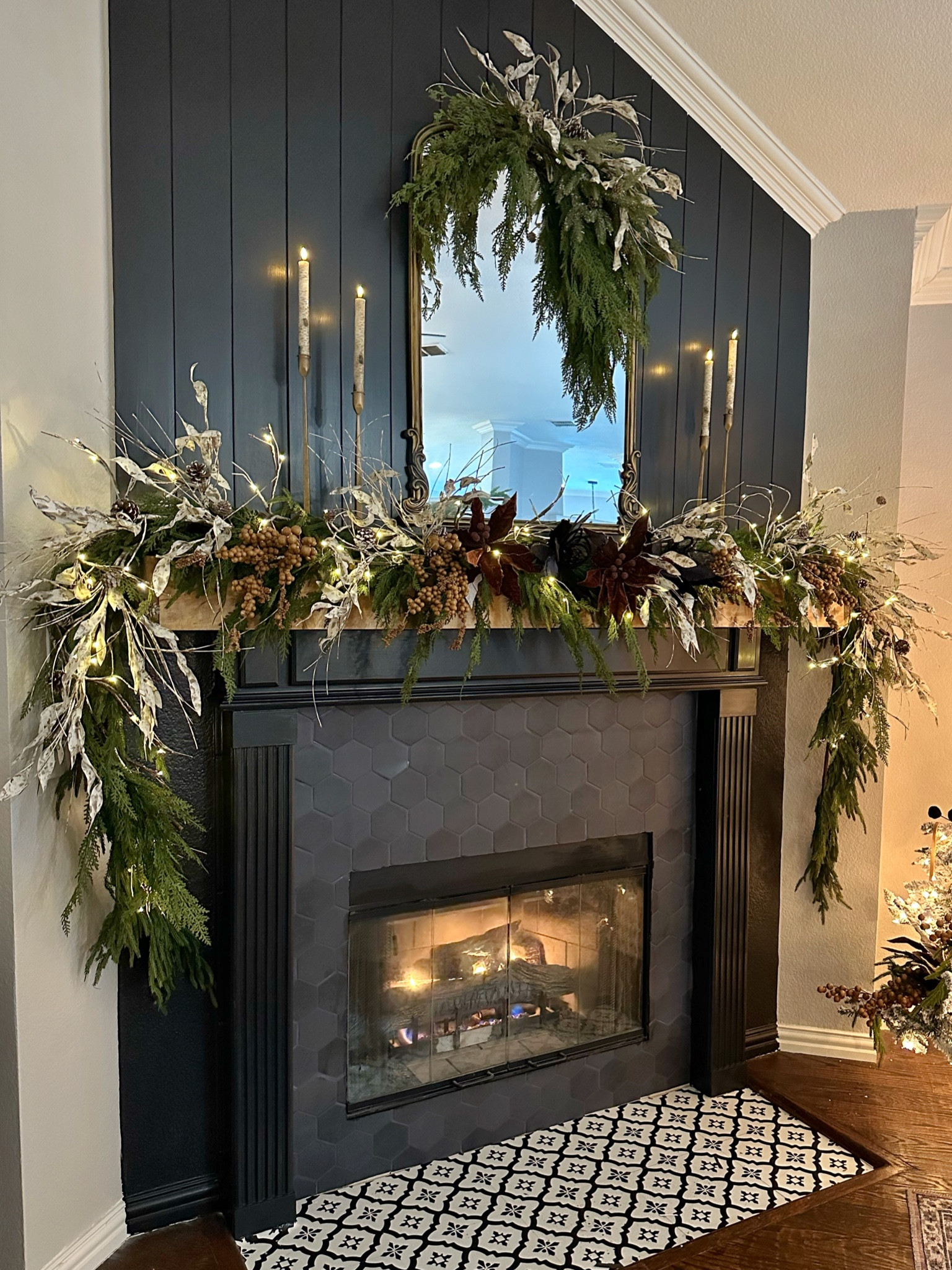 Christmas mantel inspiration with cedar and norfolk garland, berry stems, poinsettias, gold candlesticks and birch candles and picks create this dramatic moody vibe 

#LTKhome #LTKHoliday #LTKSeasonal