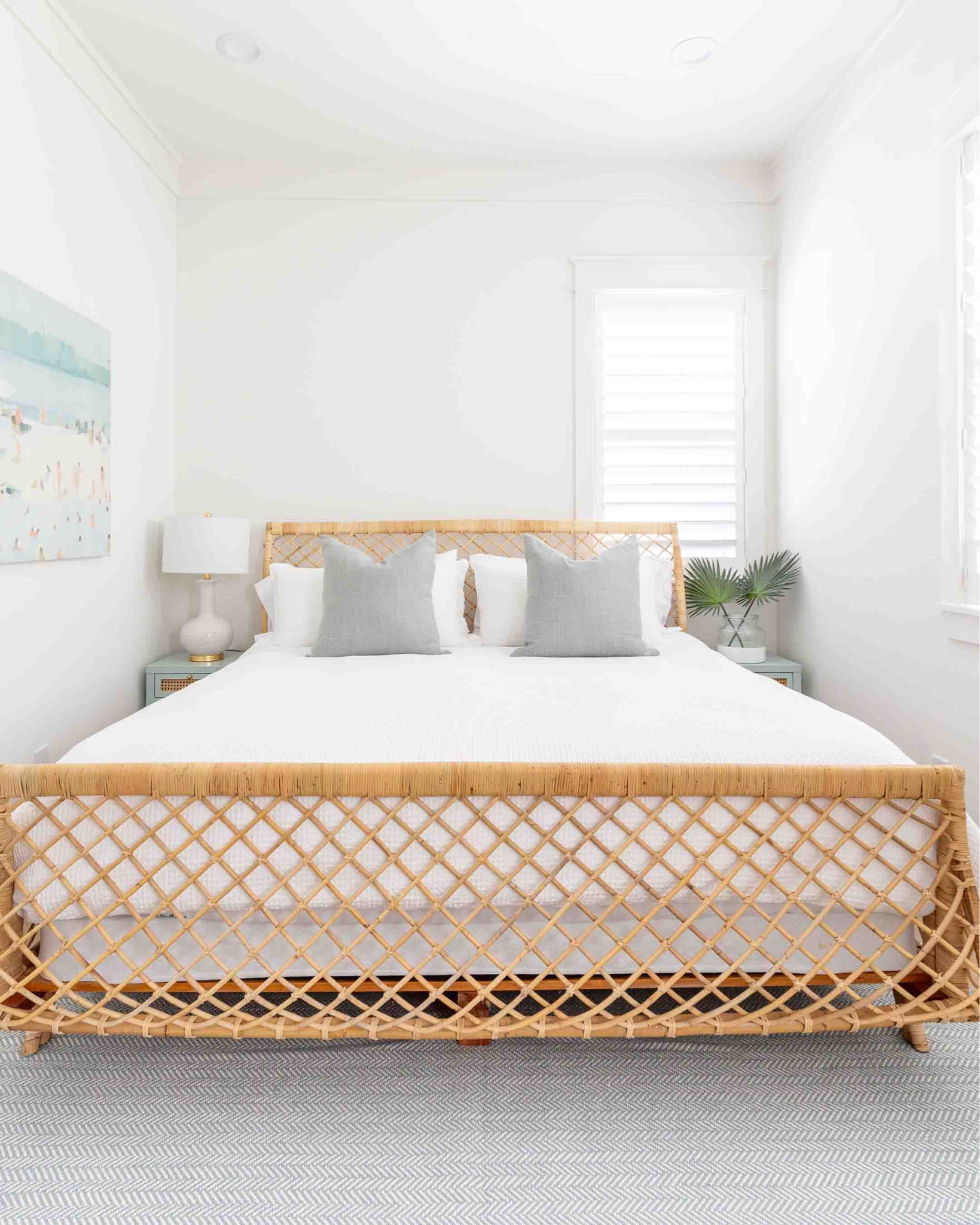 Our Florida carriage house bedroom featuring a rattan bed frame, Swedish blue herringbone rug, white waffle knit bedding, light blue and cane nightstands, beach art, white ceramic lamps, and faux palm leaves. Take the full tour here: https://lifeonvirginiastreet.com/our-florida-carriage-house-tour/
.
#ltkhome #ltkseasonal #ltkfindsunder50 #ltkfindunder100 #ltkstyletip #ltkover40 #ltktravel coastal bedroom decor, Serena & Lily style, neutral bedroom decor

#LTKhome #LTKsalealert #LTKSeasonal