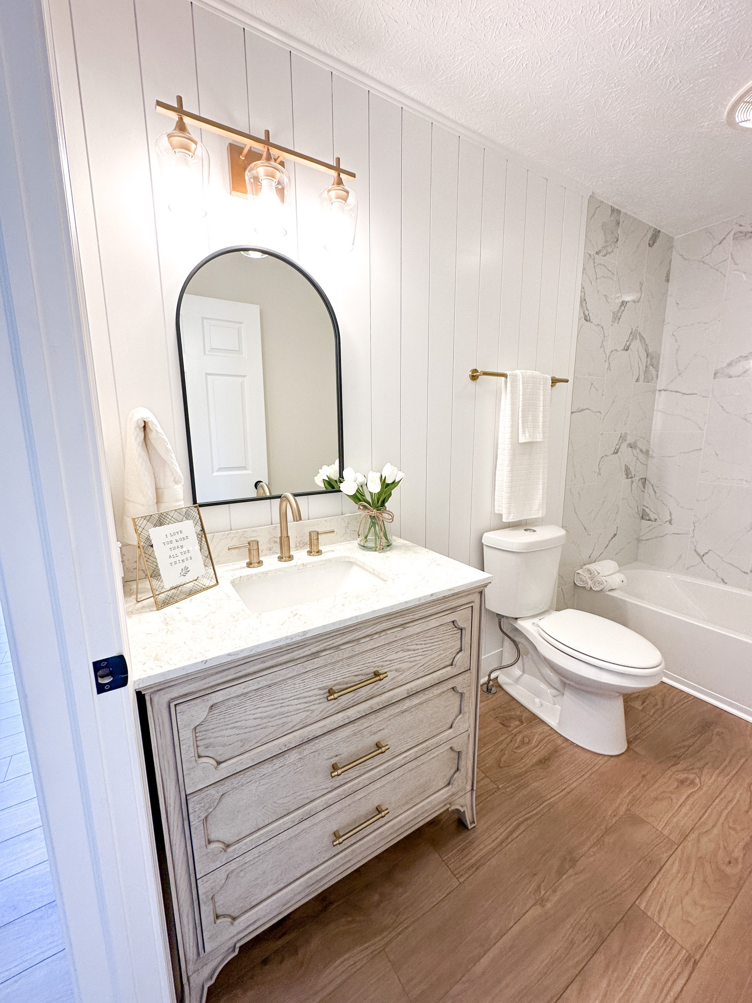 Bathroom renovation // shiplap accent // 36” vanity // lvp floors // bathroom remodel // full bath // guest bath