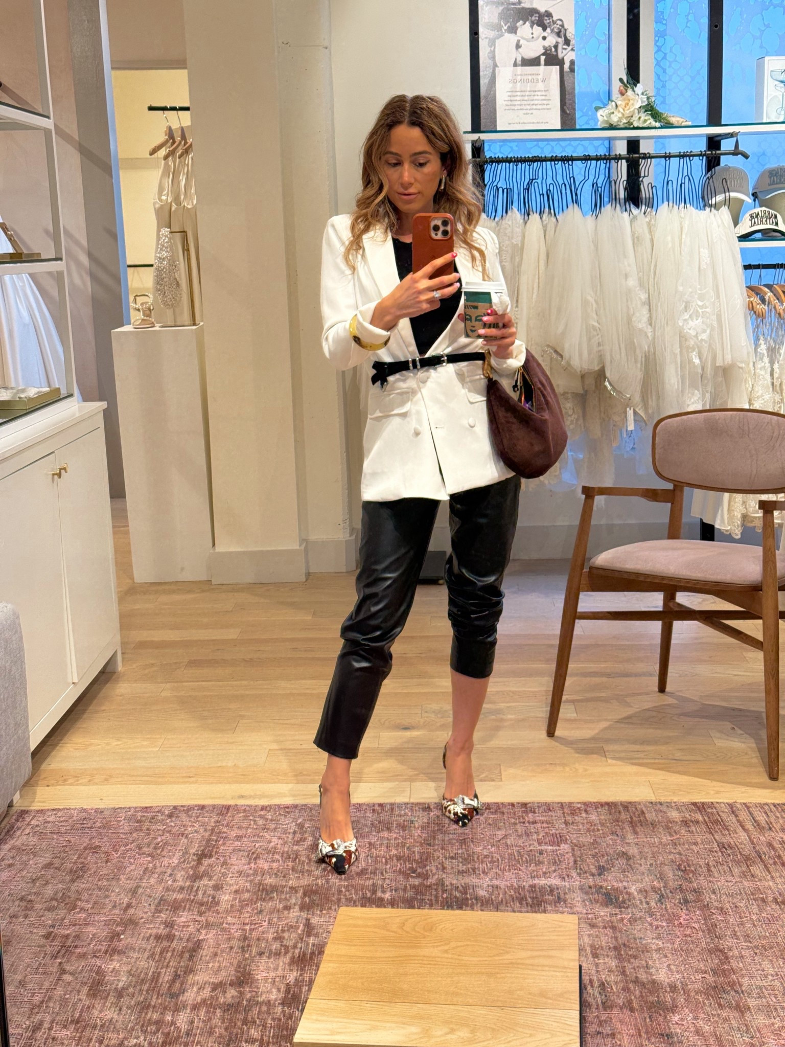 Outfit of the day. White blazer. Belted blazer outfit. Black leather pants. Cow print along back pumps. Brown suede bag  

#LTKSeasonal #LTKootd