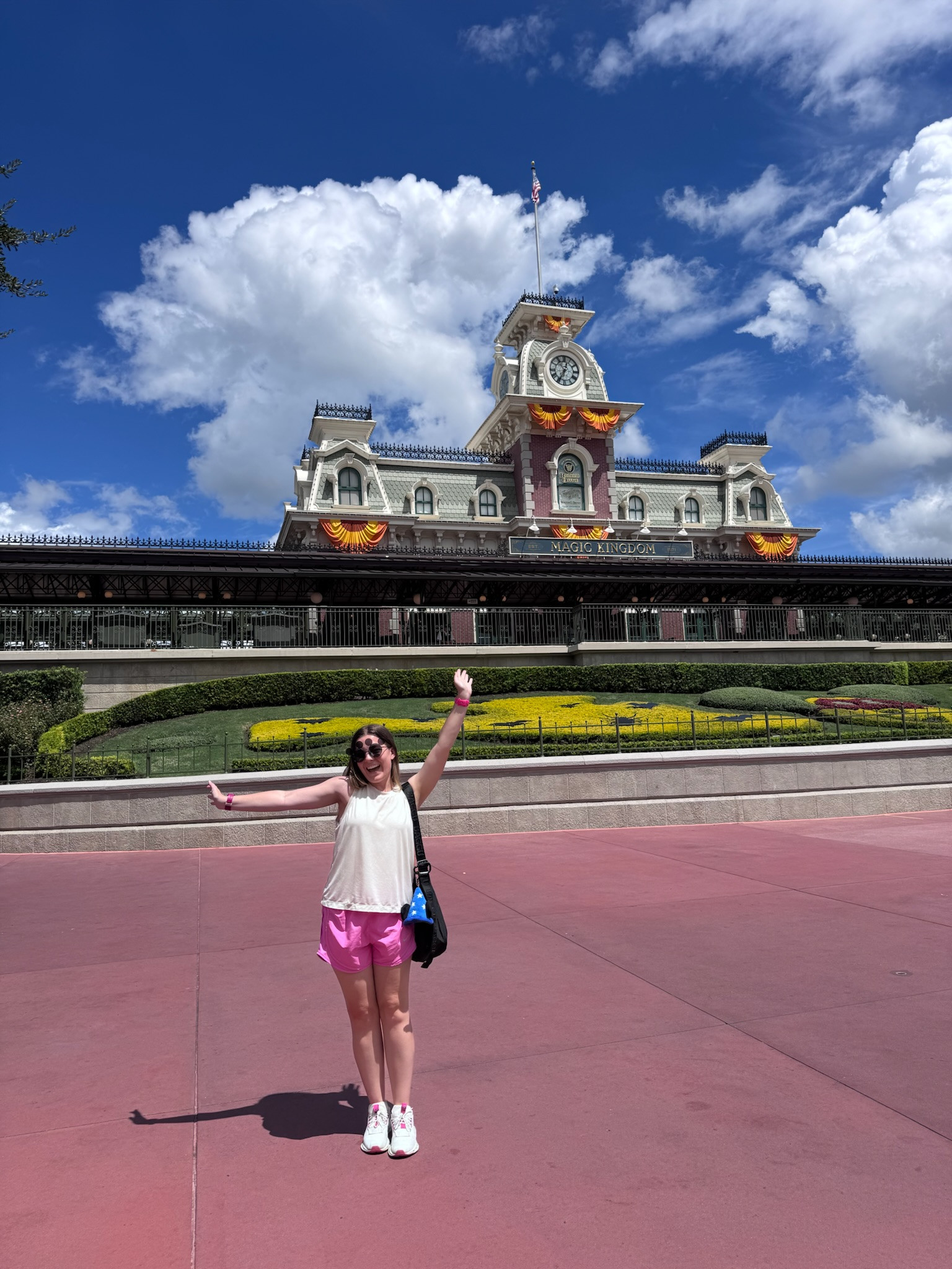 Nothing says Magic Kingdom like pink shorts and classic Mickey sunglasses! This white tank top is so light and breathable - essential for hot Florida park days. The pink satin shorts are surprisingly comfortable and catch the light beautifully in photos. White sneakers are my go-to for park days because they match everything and provide the support you need for 20,000+ steps. Black crossbody bag holds all my park must-haves! 

 #LTKootd #LTKActive #LTKTravel