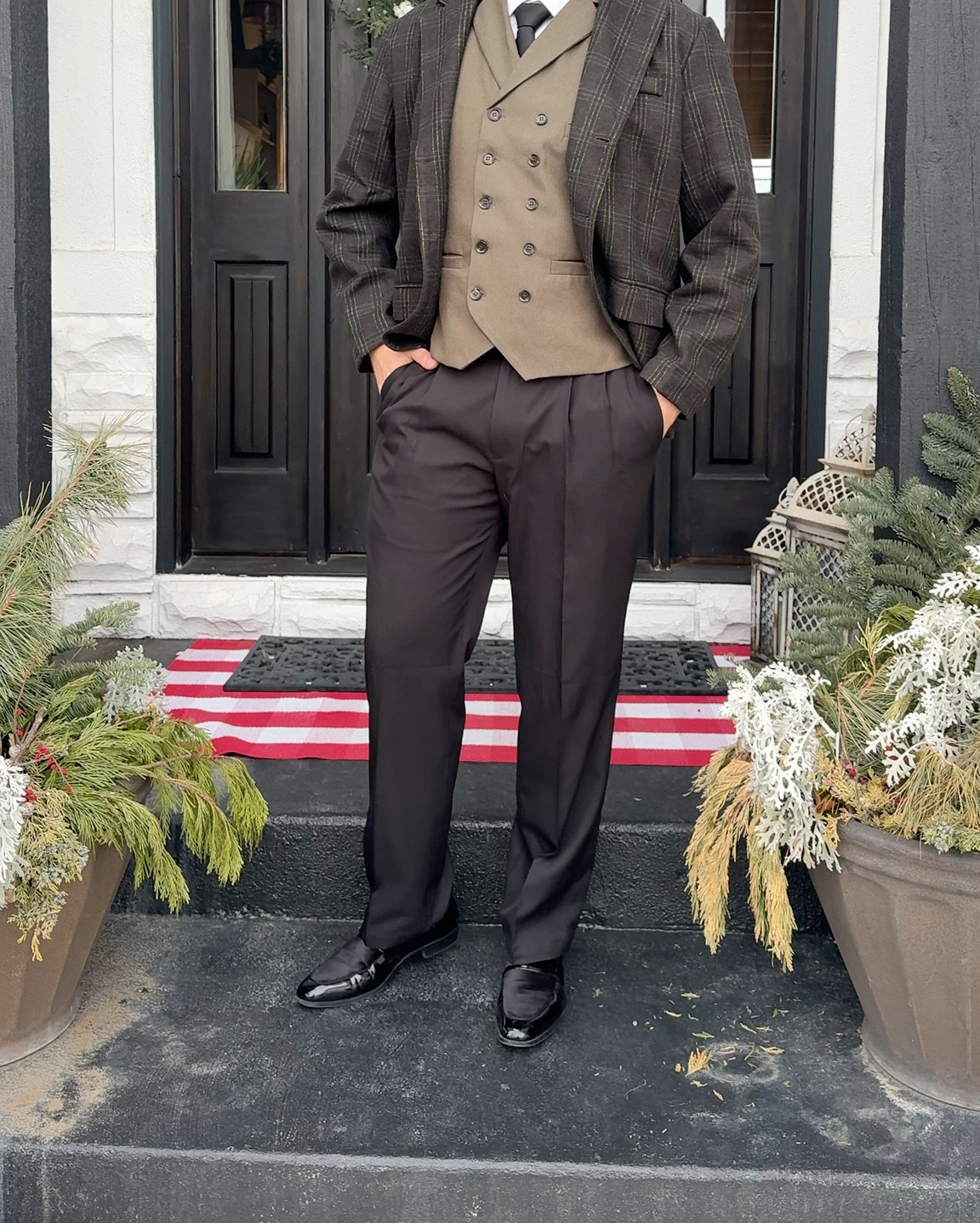
Great affordable outfit for stylish men, work event or dressy
brown/olive-green plaid pattern jacket and vest, 
white shirt, dark tie, 
black dress pants, and 
shiny black dress shoes. 

— he looks like the one who planned the outfit or is heading to Dinner/event,something more formal.

#LTKWorkwear #LTKMens #LTKNYFW