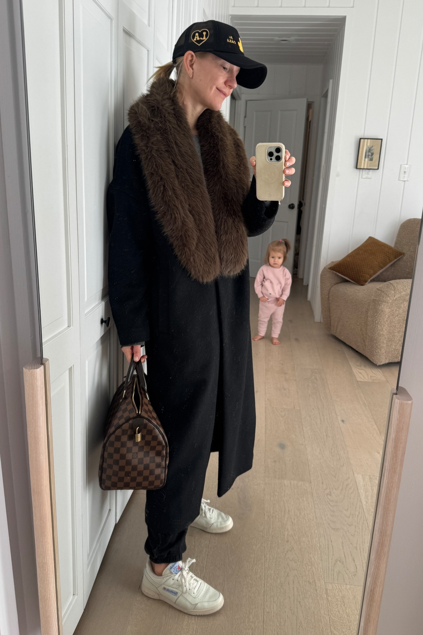 This $23 faux fur collar is SO soft and the perfect way to update an old wool coat for 2025! It comes in tons of colors—go neutral like I did or try a bright pop like red. I especially love it styled with sneakers and a baseball cap for a high/low mix! #winterstyle #winteroutfit #fauxfur
