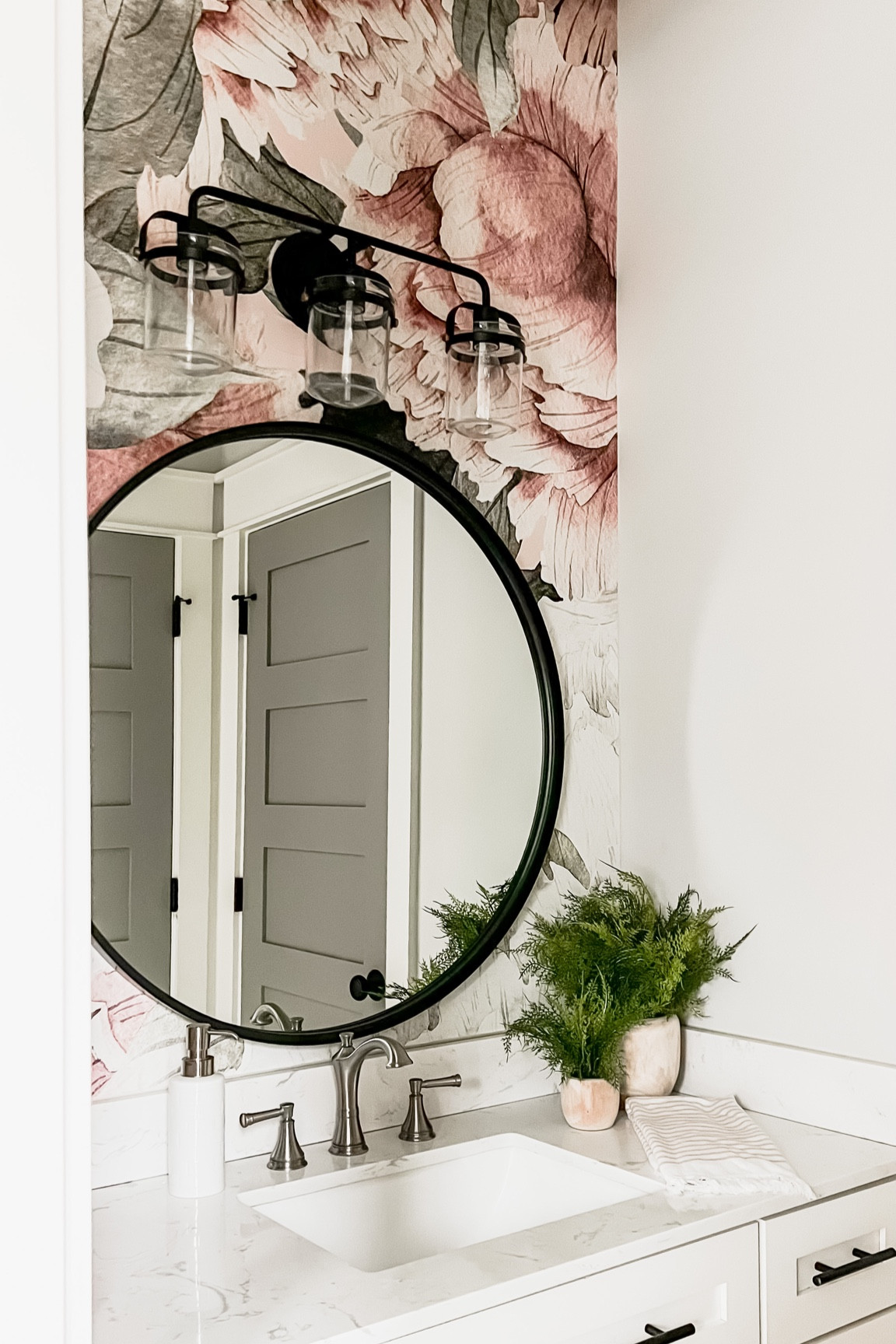 Girls bathroom vanity blush floral vintage flower peony wallpaper pink nursery kids room baby girls bedroom vanity wall sconce light fixture faux greenery large black round mirror studio mcgee wayfair lowes homedepot counter top with built in sink delta faucet bar pulls cabinet handles

#LTKunder100 #LTKhome #LTKkids