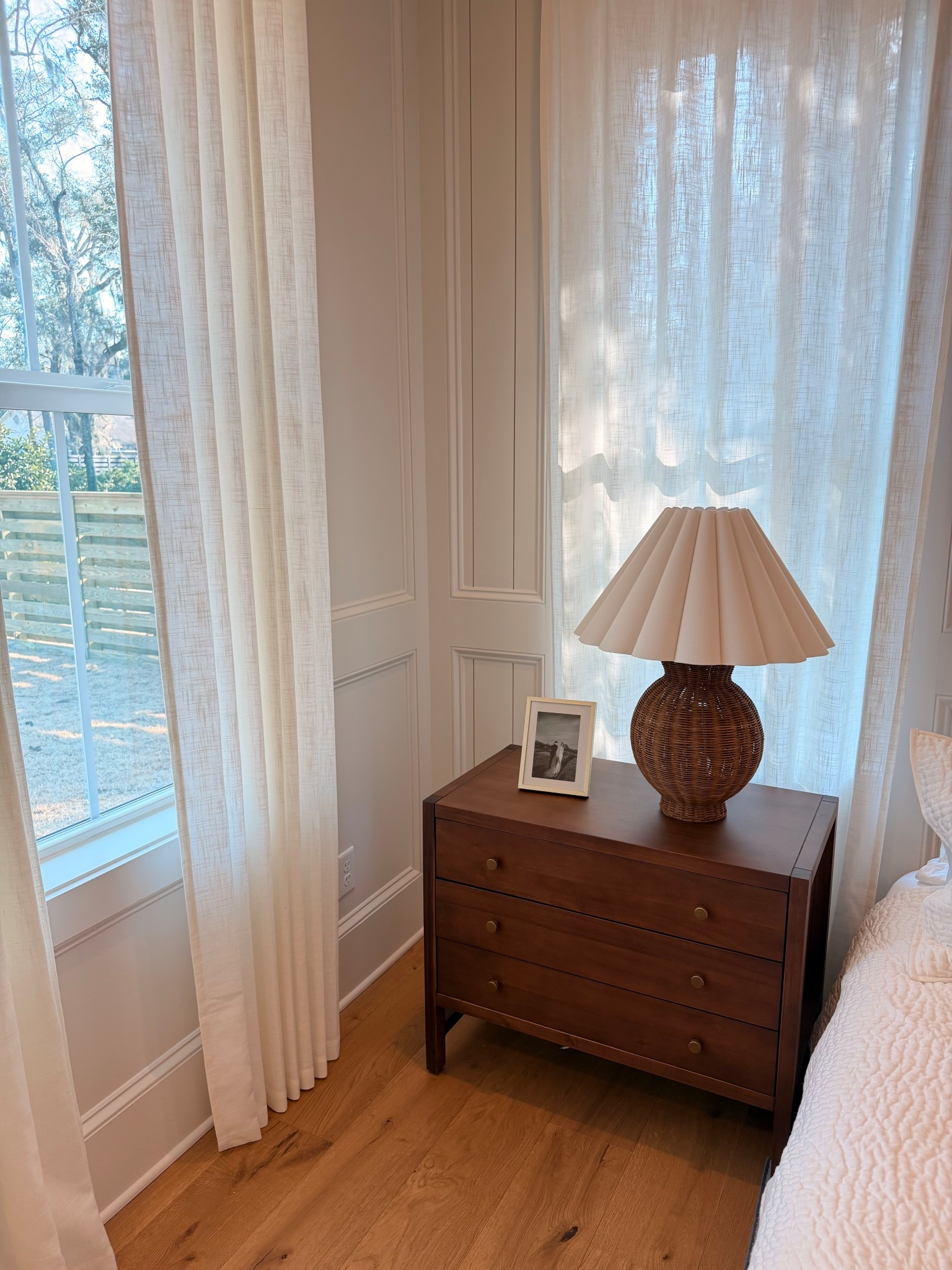Airy neutral bedroom lamps, walnut wood nightstands and pinch pleat curtains 
#ltkhome 