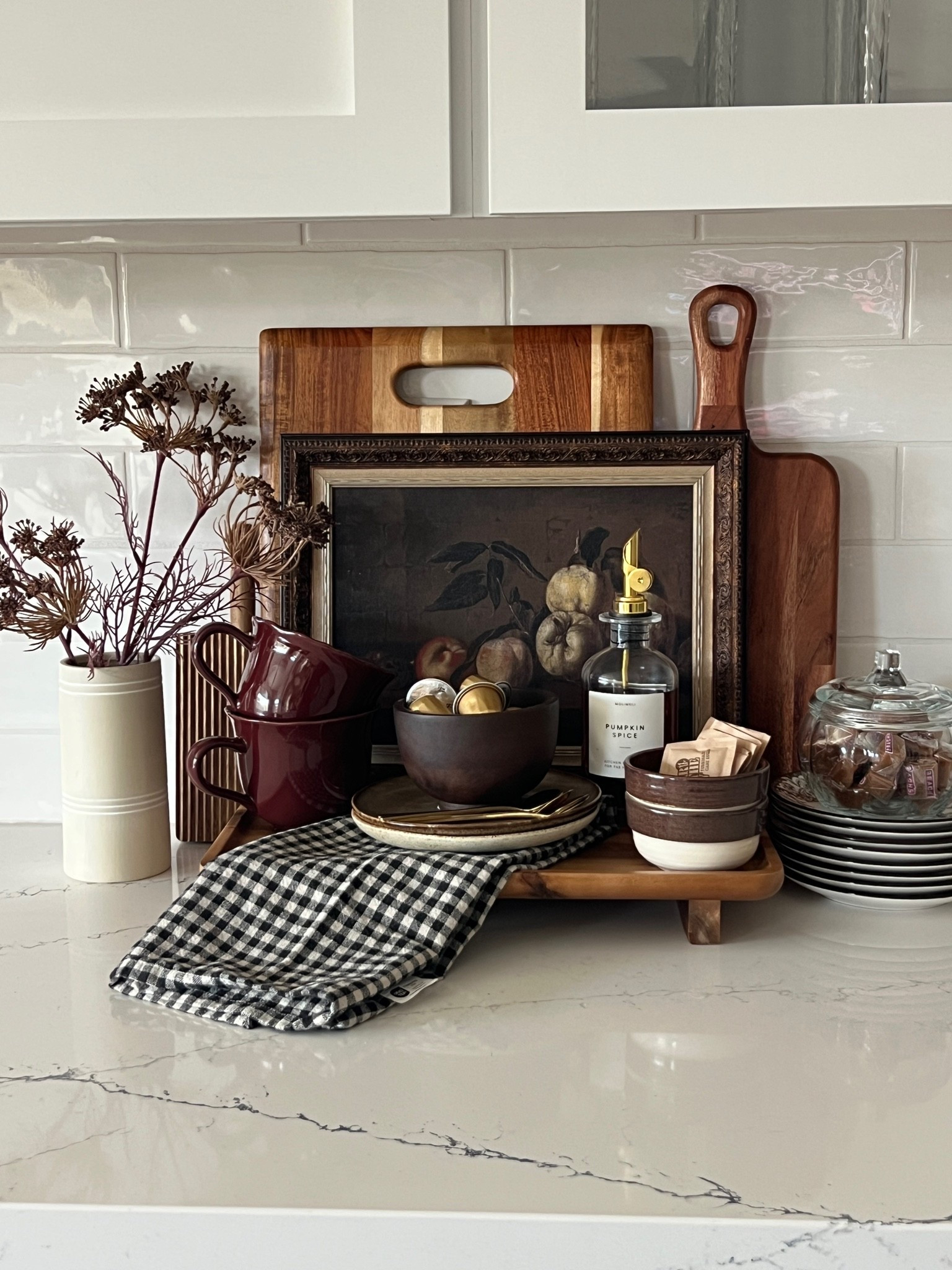 Fall coffee bar, moody fall decor, fall kitchen styling, fall hosting, autumn hosting ideas, cozy coffee bar, seasonal coffee station, brown fall decor, burgundy fall decor, chocolate brown kitchen decor, warm wood accents, vintage inspired fall decor, fall kitchen accessories, fall mugs, brown mugs, appetizer plates, decorative plates, plaid kitchen towel, gingham kitchen towel, fall serving pieces, glass candy jar, caramel candy display, pumpkin spice syrup, coffee syrup dispenser, fall stems, dried fall florals, vintage fruit art, cutting board styling, layered kitchen decor, cozy kitchen corner, neutral fall decor, traditional fall colors, elevated fall decor, fall entertaining, hostess essentials, fall tablescape inspiration, seasonal home styling.

#LTKSeasonal #LTKHome #LTKSaleAlert