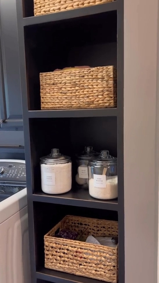 Clean & Organized Laundry Room! The baskets look aesthetic but also hide the junk! #organizationbaskets #wickerbaskets #liddedjars #baskets #organization 

#LTKHome #LTKFallSale #LTKFindsUnder50