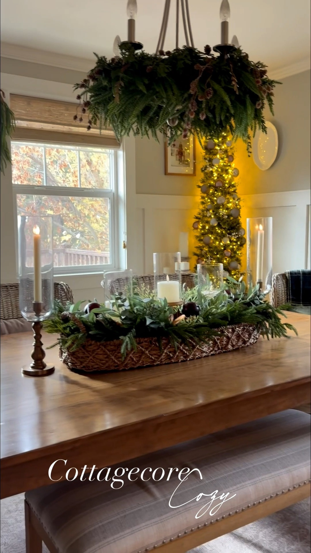 ✨ Cottage-core charm meets winter warmth. My natural wood table and wicker chairs set the coziest foundation, with a woven long basket filled with Norfolk eucalyptus-citrus greenery and soft hurricane candles glowing down the center. A slim pencil tree twinkles in the corner, and a Ralph Lauren–inspired mix of velvet and moody tartan adds that layered, collected feel. It’s a dining room that feels storied, soft, and ready for slow winter dinners. ✨

#CottageCoreDecor
#CozyDiningRoom
#HolidayHomeInspo
#WarmWinterDecor
#CollectedHomeStyle

#LTKSeasonal #LTKHoliday #LTKHome