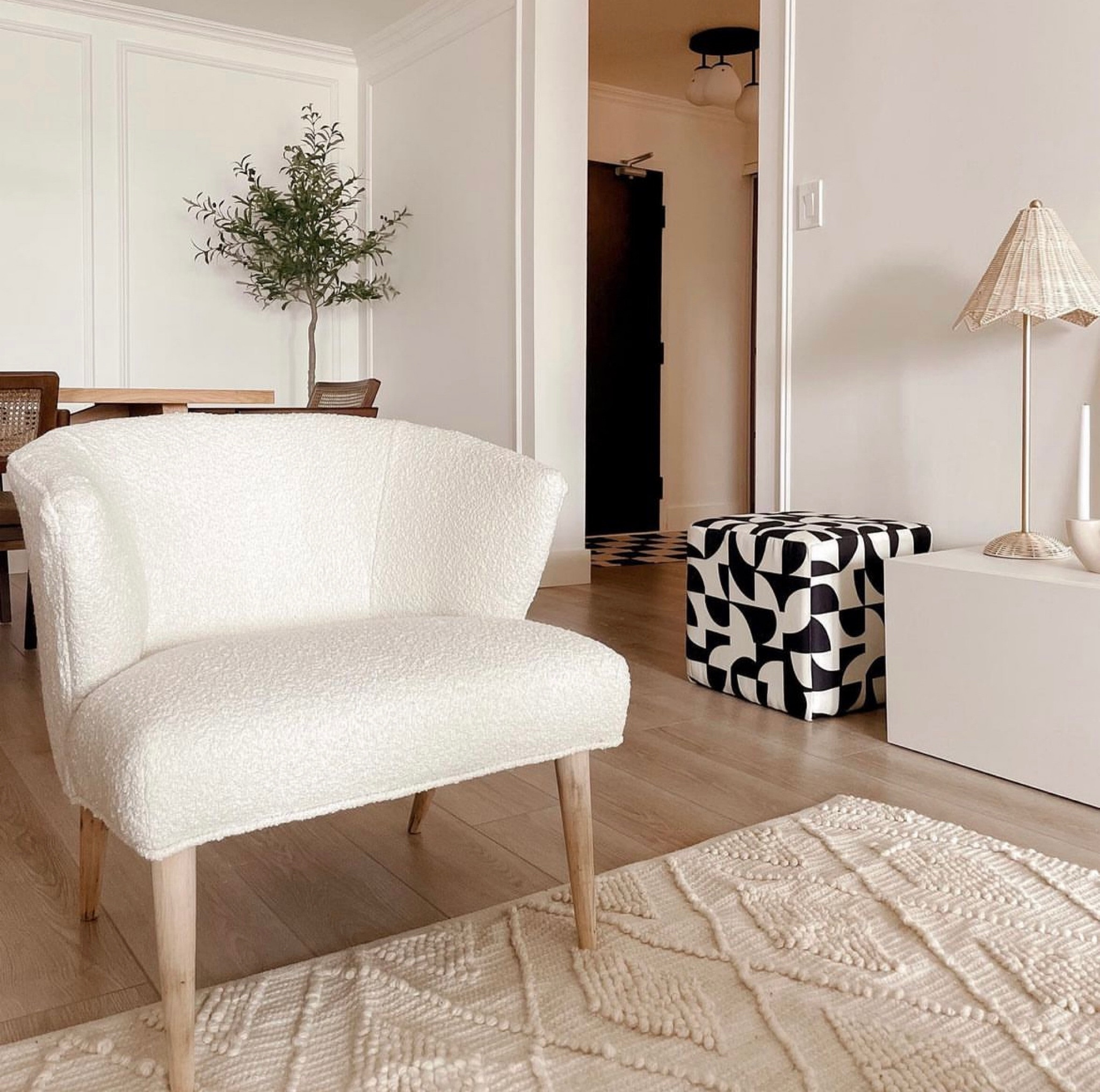 In my home, a corner of the living room and open concept dining room. 

Sherpa chair, patterned pouf ottoman, black and white decor, aesthetic living, faux tree

#LTKhome #LTKstyletip #LTKFind