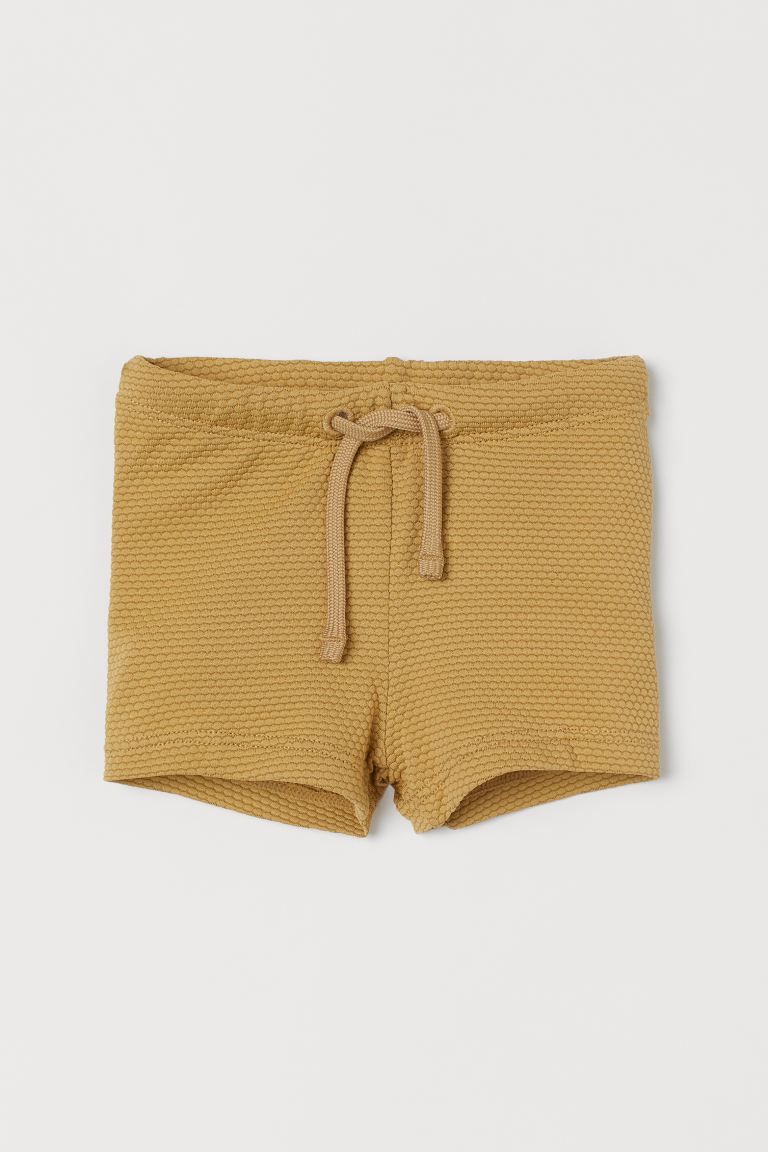 Baby Exclusive. Textured swim trunks. Elasticized waistband with drawstring. Lined front. | H&M (US + CA)