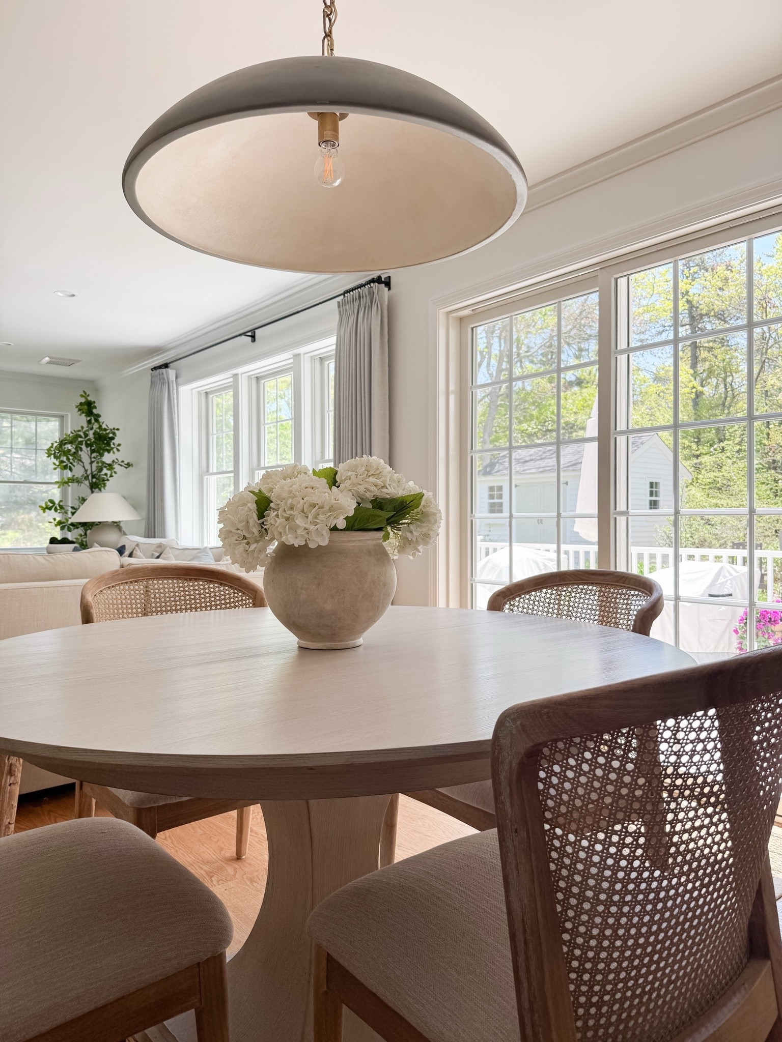 coastal dining room decor, round wood dining table, woven dining chairs, faux hydrangea centerpiece, neutral dining room styling, coastal interior decor, light coastal home, neutral dining room inspiration, sherricalnanhome

#LTKHome
