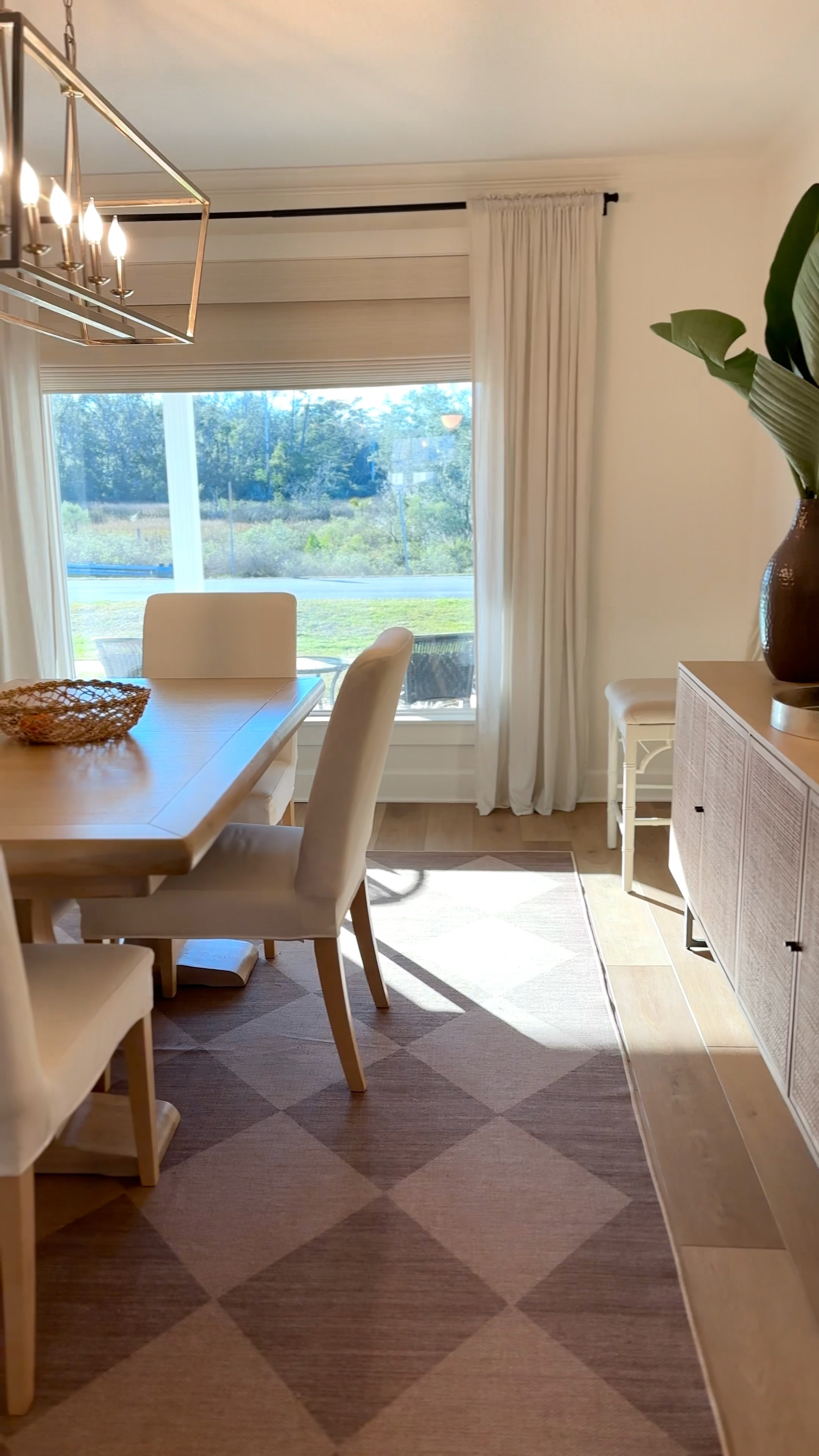 Dining room decor 
Washable rug 
Rattan console 
Cane console table 
Coastal lighting 
Woven lamp 
Wooden dining table 
Large round mirror 

#LTKfindsunder100 #LTKhome #LTKsalealert