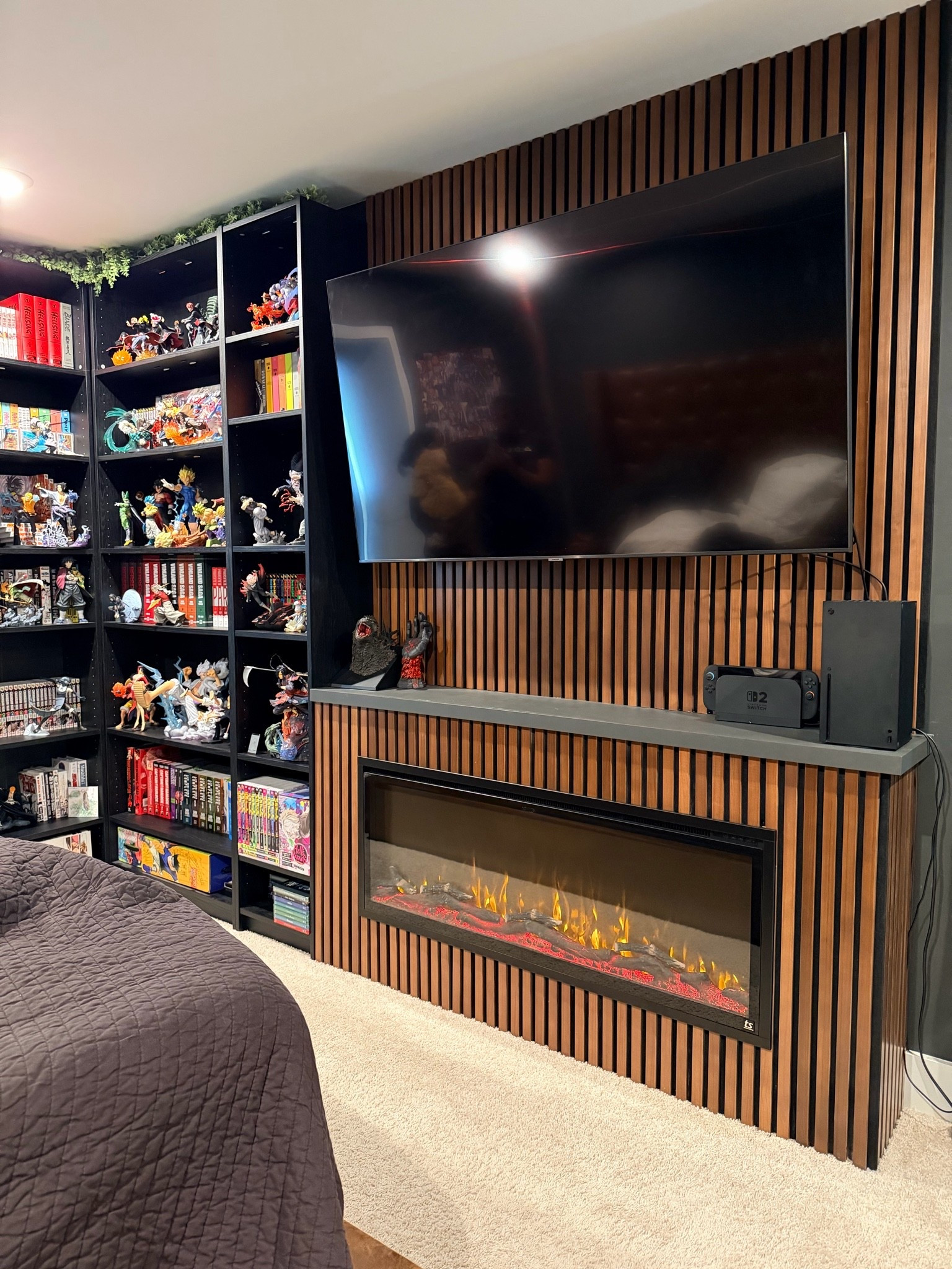 This custom media wall might be one of my favorite projects we’ve completed! 🤎 The warm wood slat detail, sleek linear fireplace, and built-in shelving completely transformed this room into the ultimate cozy retreat. It’s the perfect blend of modern design and personality giving all the collectibles a dedicated home while creating a statement focal point.

If you’re looking to elevate a bedroom, loft, or media room, a slat wall fireplace feature is such a game changer. The warmth, texture, and ambiance it brings make the space feel custom and high-end without sacrificing function.

#LTKHome #LTKKids #LTKMens