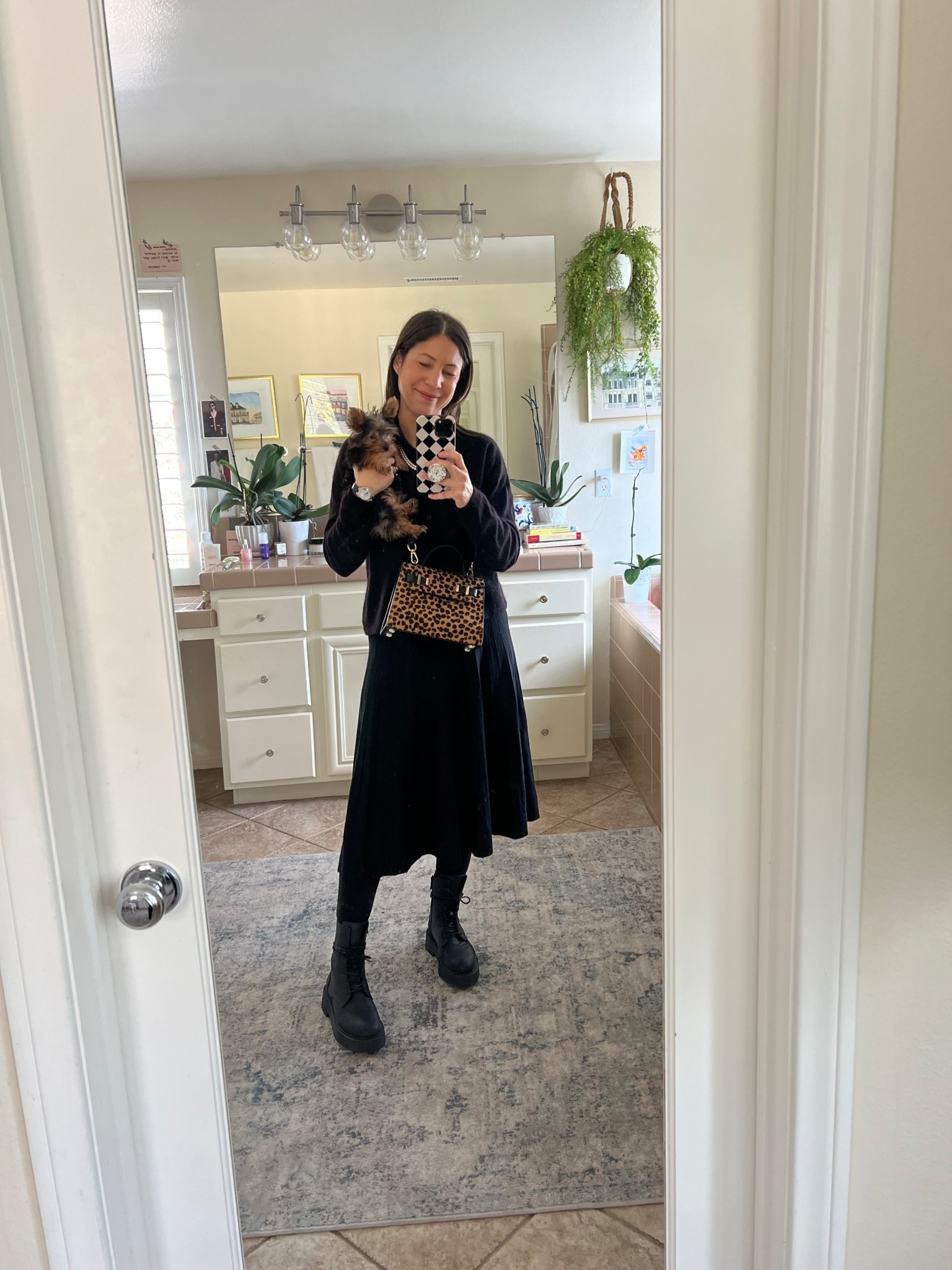 Today, Watson and I are ready for anything in a look that feels both demure and delightfully edgy. Here’s what I’m wearing:
🖤 Pleated wool skirt (from LilySilk — soft, cozy, and elegantly flows with every step)
🖤 Black cashmere cardigan (also LilySilk — an instant classic that keeps you warm while feeling luxurious)
🖤 Black opaque tights (I’m loving my Hipstik pair — perfect for the season)
🖤 Edgy boots — my trusty Thursday Boots Quest style (a nod to flair without sacrificing comfort)

This outfit feels like an ode to winter sophistication: the softness of wool and cashmere paired with the grounded strength of great boots makes it both chic and practical. I adore how the pleats give movement to the silhouette, while the black-on-black palette feels calm, classic, and quietly confident.

✨ Style tip: When building a look that’s primarily one color, mix textures, think wool, cashmere, matte tights, and leather for depth and interest.
What’s your go‑to winter outfit that feels both cozy and polished?

#OOTD  #moodyChic #TenItemWardrobe 

#LTKgrwm #LTKOver40 #LTKdayinmylife