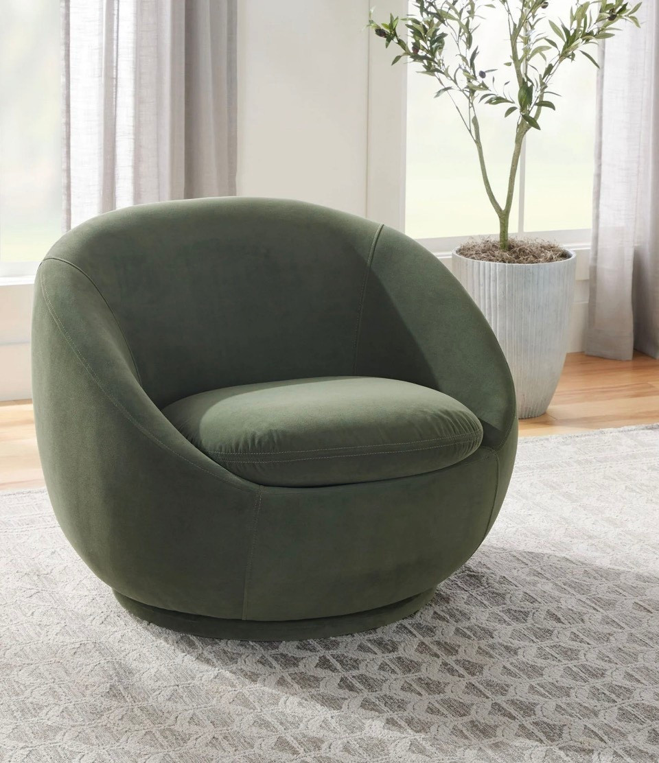 The Better Homes and Gardens Mira Swivel Chair, Olive, brings timeless style and cozy comfort to any room. Its versatile design complements living rooms, home offices, and beyond, with a luxurious green velvet fabric that exudes sophistication. Soft and supportive, the chair provides long-lasting comfort, while a sturdy solid wood frame ensures durability. The 360-degree swivel base facilitates easy conversation, and the chair arrives fully assembled for your convenience. Pair two chairs together for a comfortable conversation set