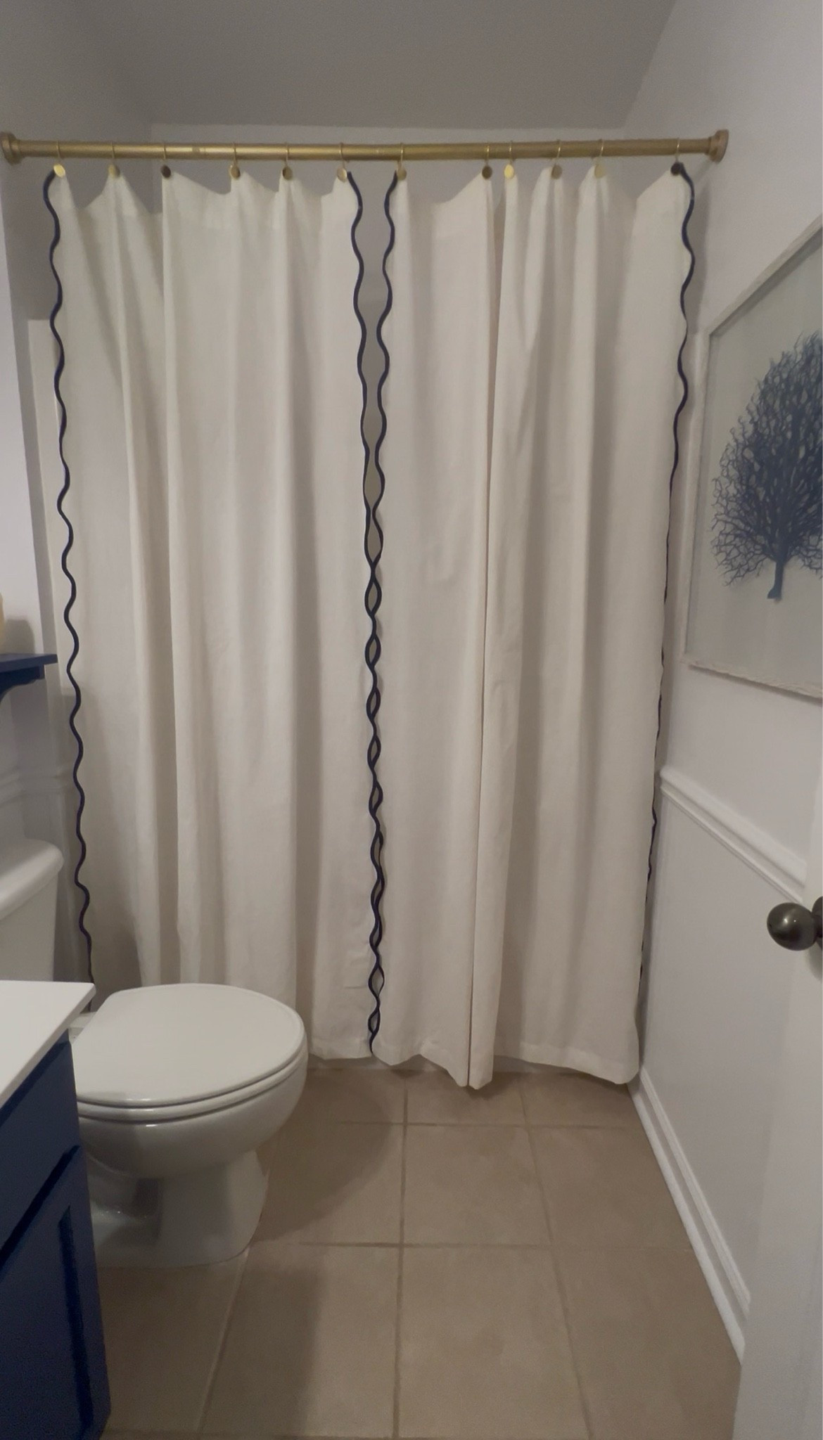 Anthropologie-inspired, Amazon budget 🤍💙

These 2-panel cream linen with navy scalloped edges + gold grommet rings are officially the actual shower curtains in our guest bathroom. 😂

Yes, we don’t shower in this bathroom, so I’m treating it like a decorative moment. The gold shower curtain rod adds just the right touch of warmth, and the coastal guest bathroom is finally coming together! ✨

Side note: I had to puncture holes in the curtains to insert the grommet rings and elevate the whole look. You can also simply put the curtain rod through the top, but I just don’t like the plain look. 
Everything is from Amazon.

#LTKHome