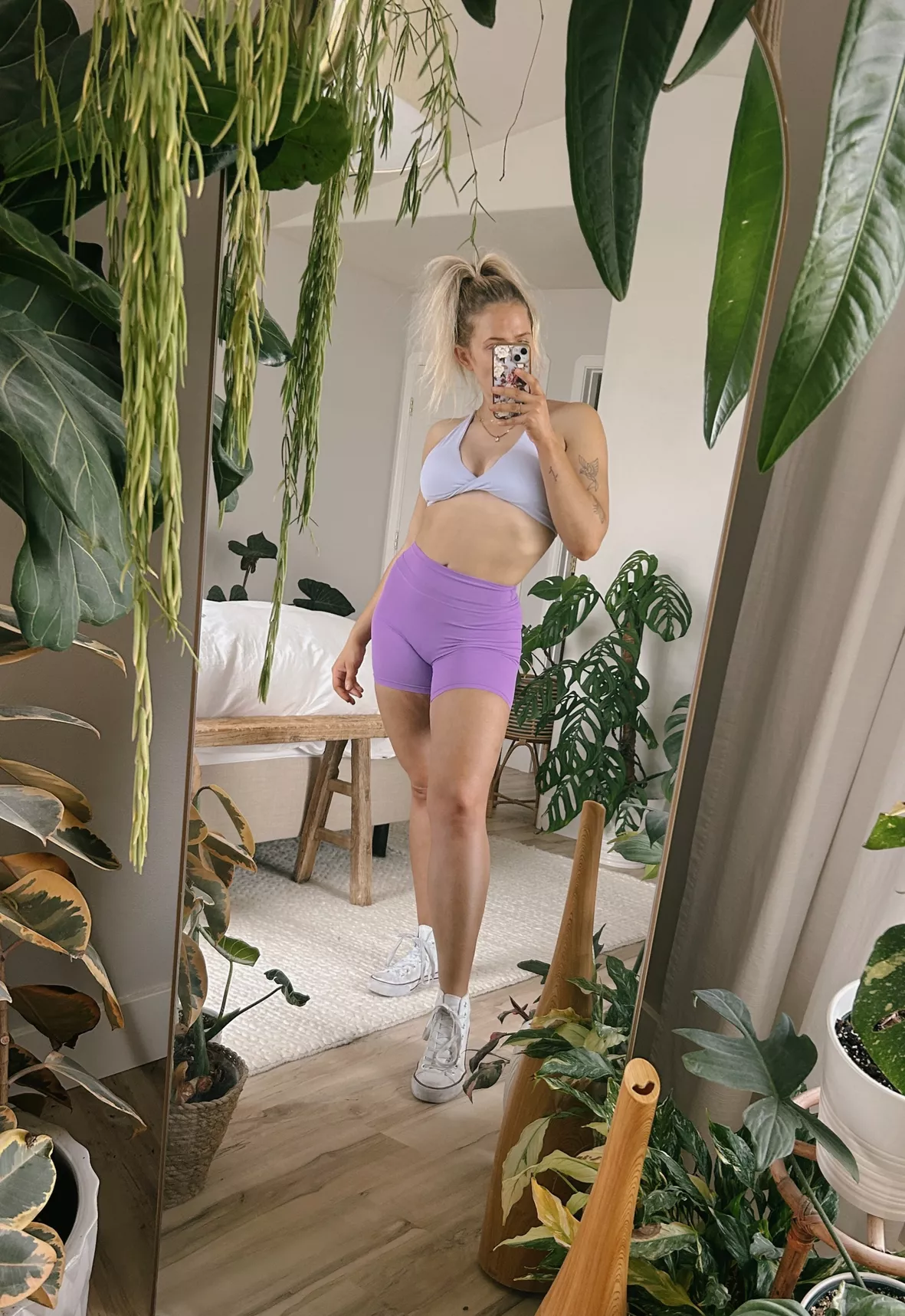 Feminine woman wearing yoga shorts and sports bra in the fitness
