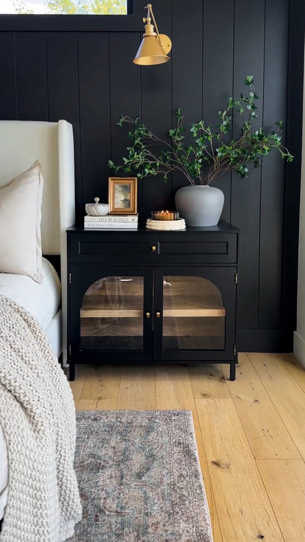Simple, layered nightstand styling that adds warmth to our black accent wall.