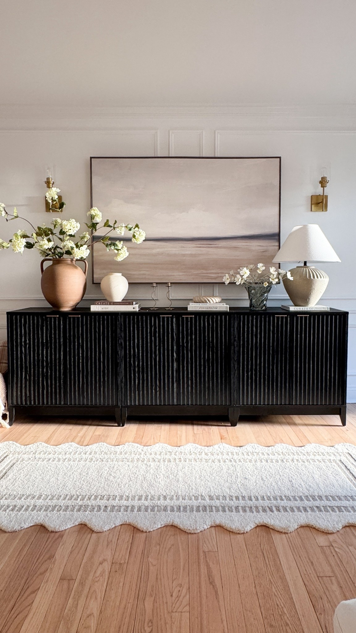 This console setup has become one of my favorite views in the house. The textured black cabinet adds just the right amount of contrast against the soft art and warm layered accents. From the sculptural lamp to the ceramic vases and coffee table books, everything here is linked for you here 🤎

#ConsoleStyling #ModernOrganicDecor #NeutralHomeVibes #BlackCabinet #EntrywayInspo #LTKHomeFinds #InteriorStylingIdeas #LayeredDecor #HomeInspo


#LTKStyleTip #LTKHome #LTKSaleAlert
