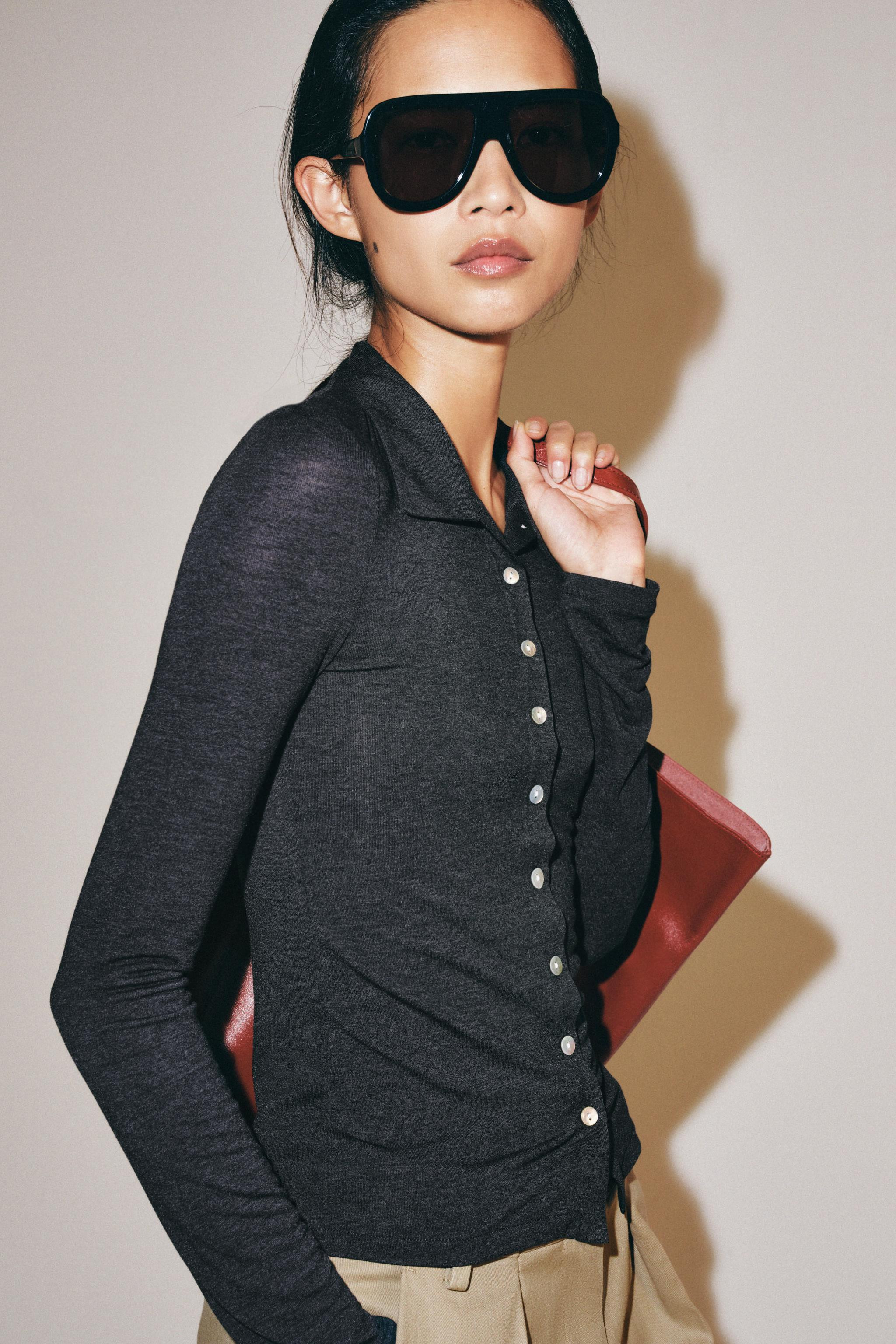 Top featuring a lapel collar and long sleeves. Straight hem. Front button closure with contrastin... | Zara US
