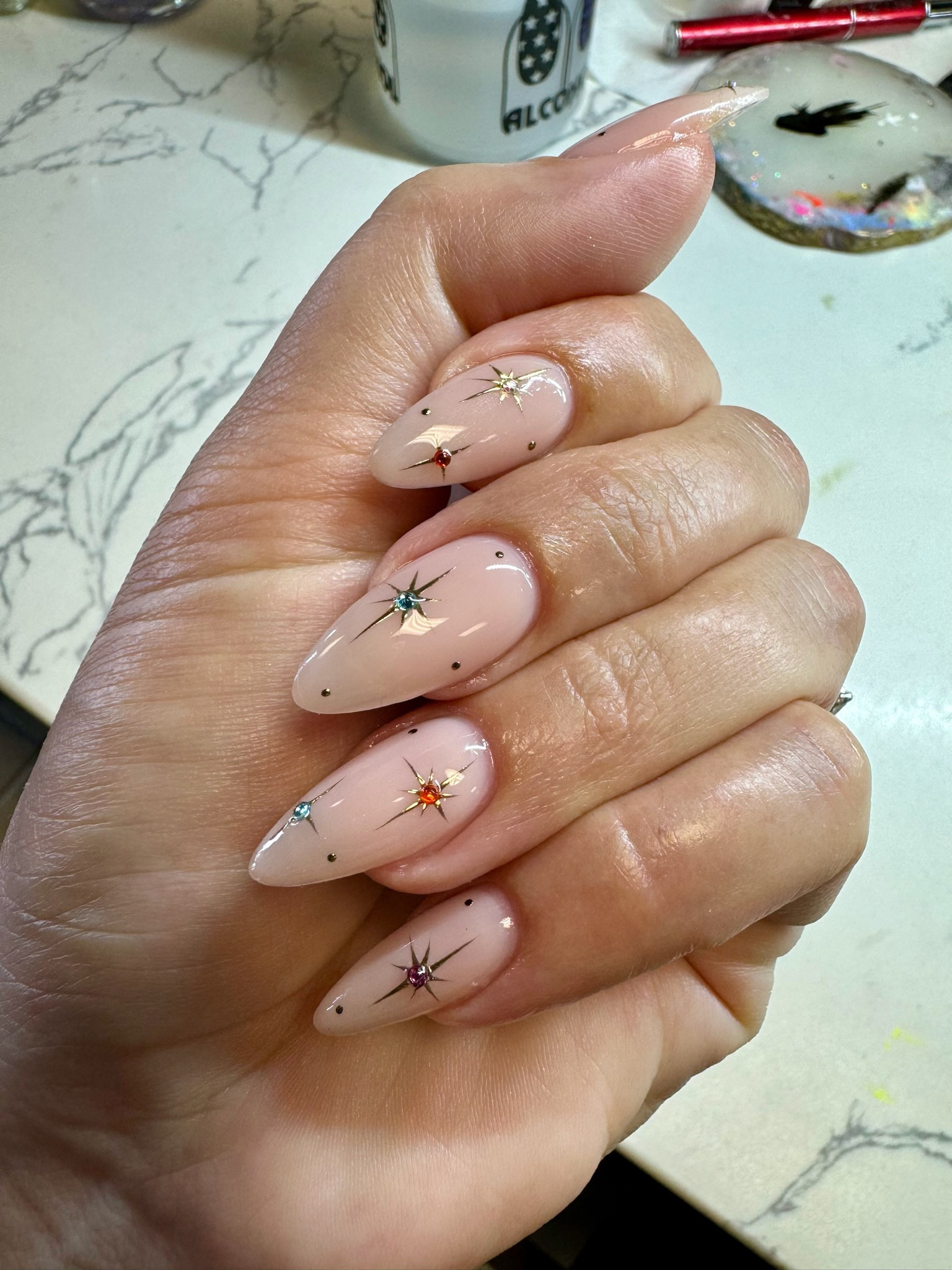 Here’s what was used to help create this look:

DND how do you neutral 
black gel chrome 
gold chrome powder
colored rhinestones
gel top coat