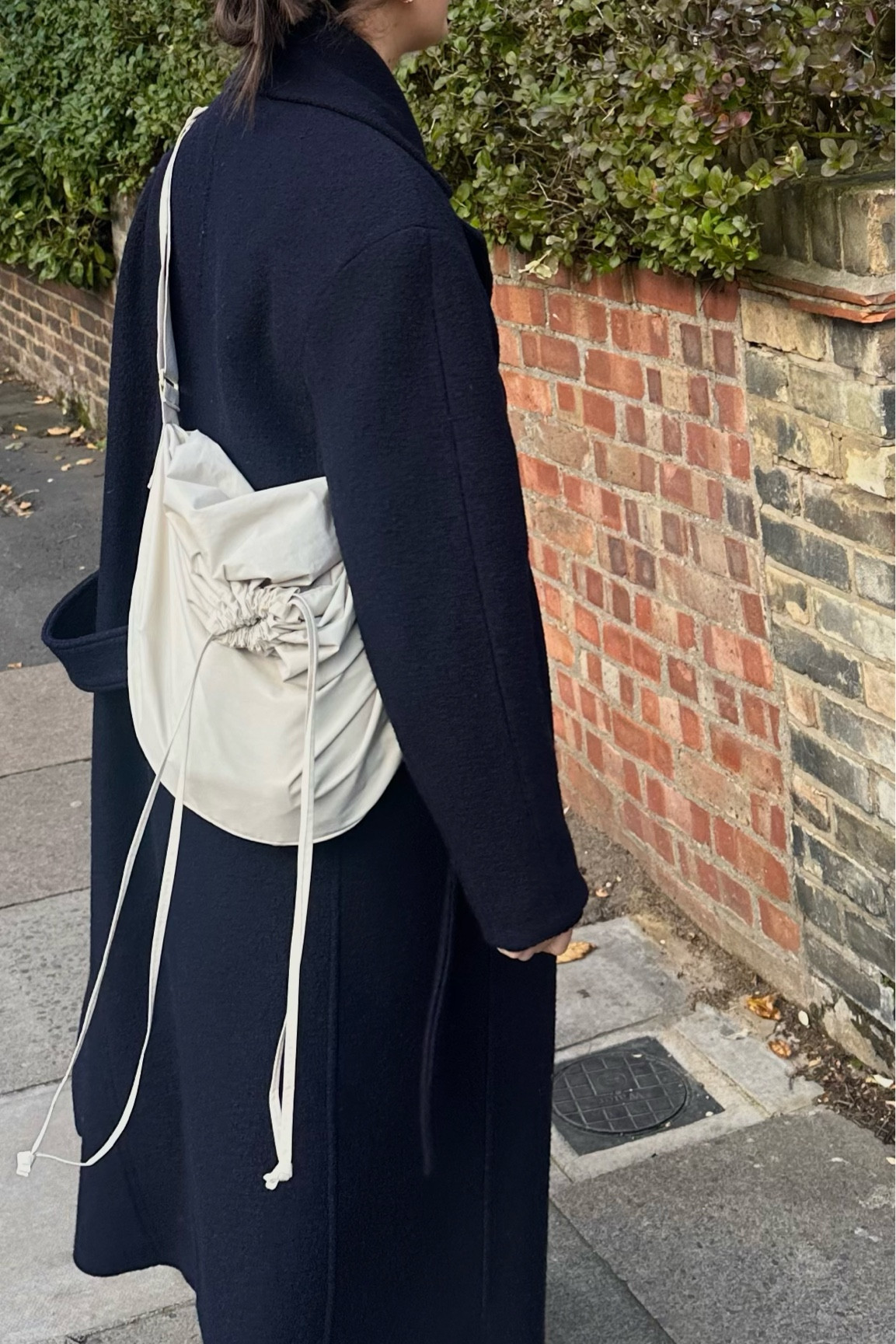Navy wool coat. Uniqlo drawstring bag. Casual winter outfit  

#LTKitbag #LTKSeasonal