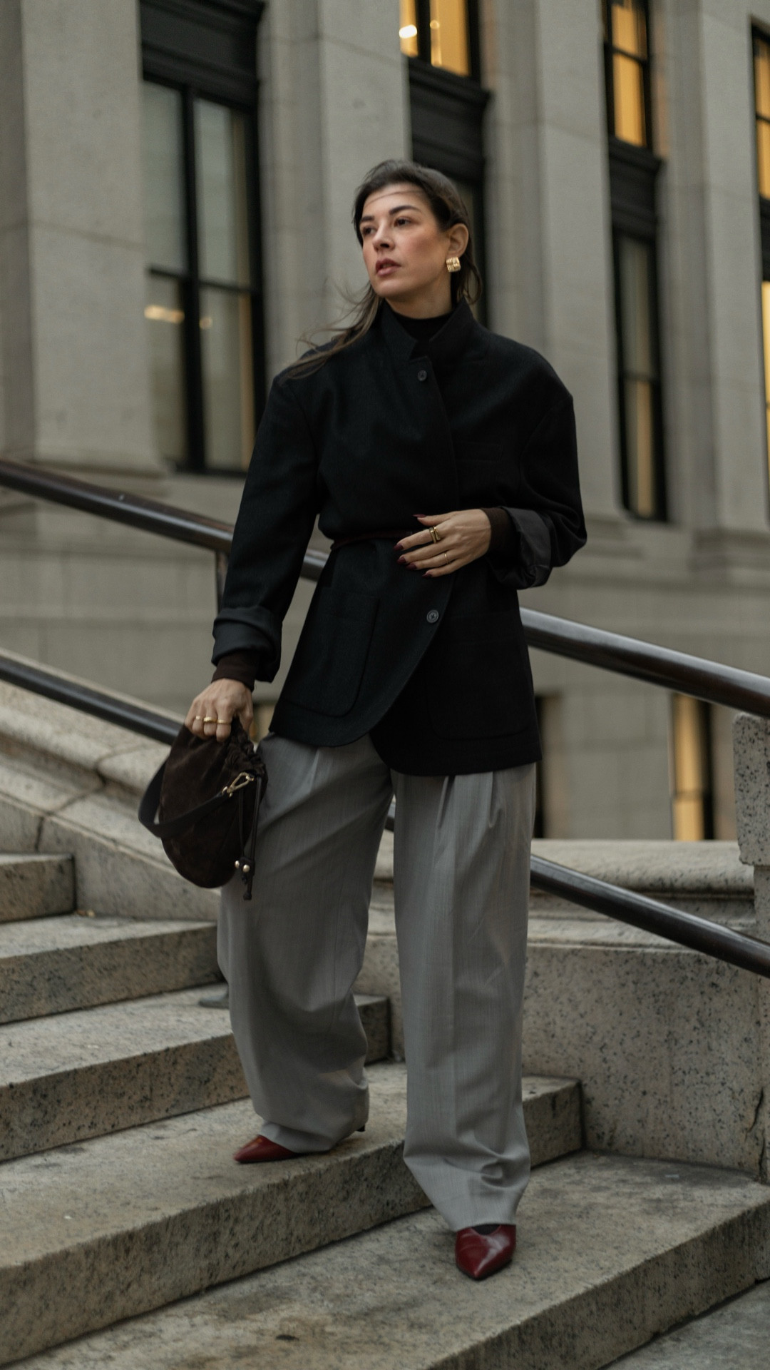 How to create a minimal chic outfit that won’t go unnoticed. 

Why this outfit works? Let’s break it down

1. Sharp proportion play: 
Oversized blazer cinched with a thin belt = structure without losing volume. Wide-leg trousers keep the silhouette long and relaxed.

2. Luxe neutrals with one intentional pop: grey and brown for a clean, minimalist base. Red cap-toe heels add an unexpected but very controlled accent.

3. Elevated textures: Wool blazer, soft suede bag, tailored trousers, all matte, rich textures that photograph beautifully together.

4. Smart accessory minimalism: A single pair of statement earrings and a belt. Everything feels deliberate, not crowded.

5. Effortless attitude: The relaxed hair and natural makeup balance the structured pieces, keeping the look modern, not stiff.

✨ To recreate this outfit:
	•	Start with two neutrals (e.g., black + grey).
	•	Choose one structured piece (blazer) + one relaxed piece (wide trousers).
	•	Cinch the blazer with a slim belt to shape the silhouette.
	•	Add one bold accent (shoes or bag—just one).
	•	Keep accessories minimal but intentional.

Let me know what you like about this look and stay for more educational aesthetic fashion content! #anatomyofanoutfit

#LTKWorkwear #LTKStyleTip #LTKootd