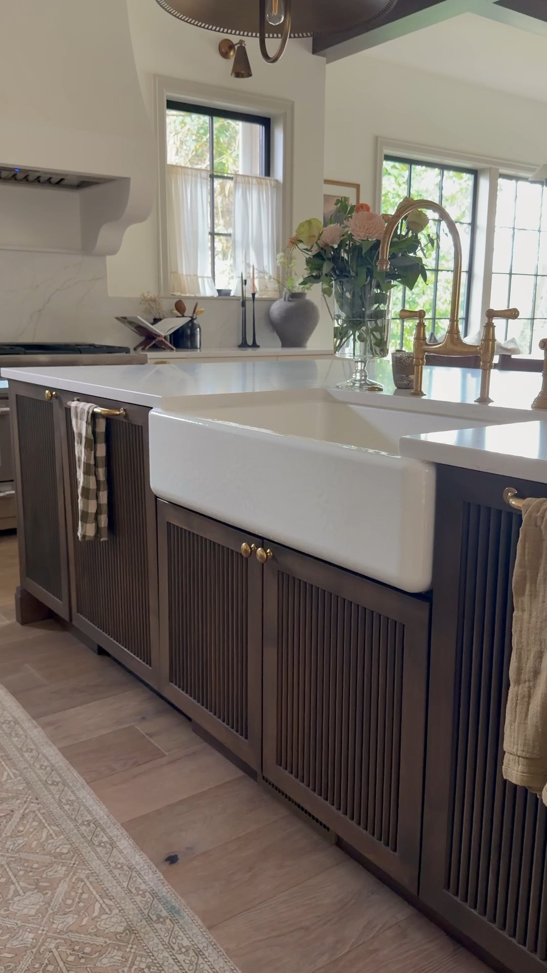 • Cabinet style: Fluted panel detailing with open shelving + legs for a furniture-style feel
• Paint color: Natural Cream by Benjamin Moore
• Hardware: Unlacquered brass pulls
• Stain: Custom walnut stain on the open shelving
• Countertop: [Add your slab here — happy to tweak if you send it!]

We really wanted the island to feel like a standalone furniture piece rather than built-in cabinetry — warm, layered, and timeless.

#LTKHome