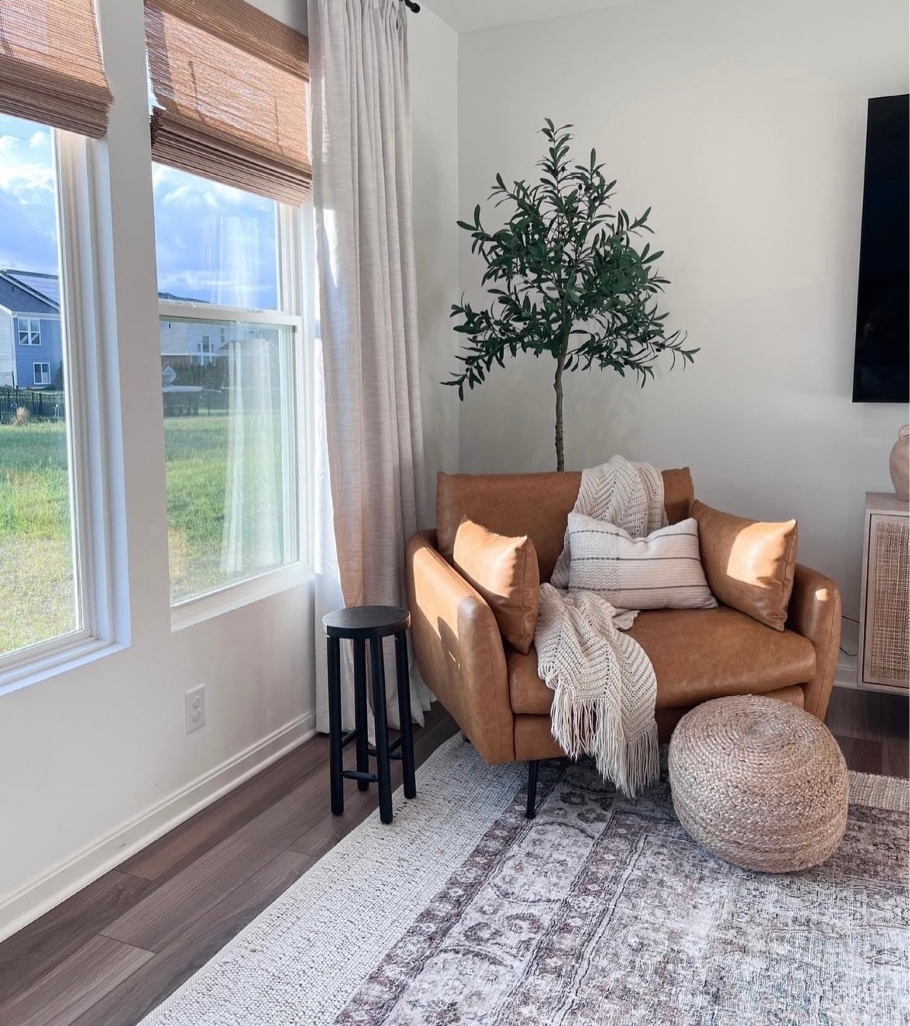My woven pouf is over 60% off right now! 

Leather accent chair, bamboo shades, pinch pleat curtains, black side table, olive tree

#LTKhome #LTKFind #LTKsalealert