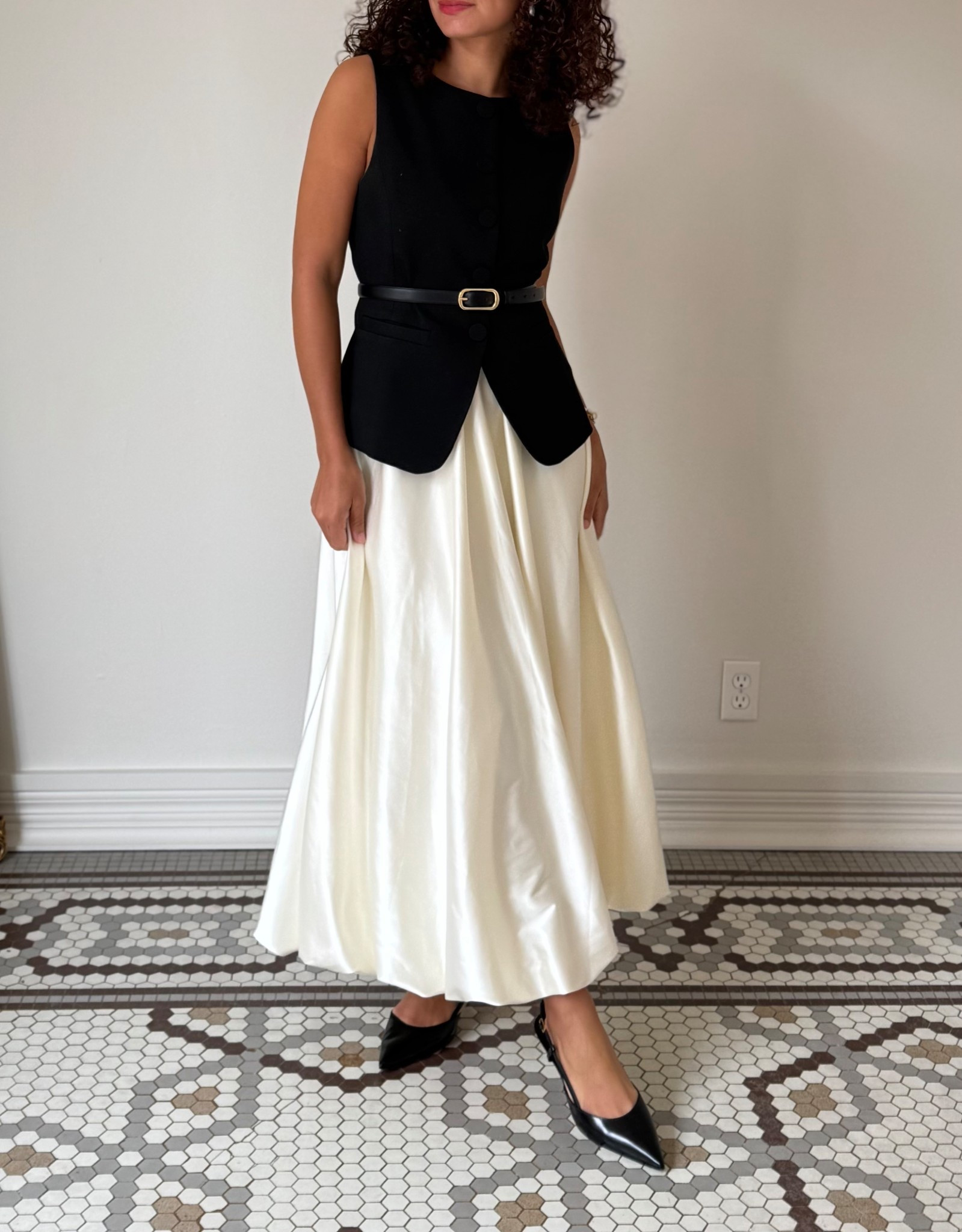 Embrace classy style with a midi/maxi bubble skirt, black longline vest, belt, pearl bracelet, and slingback heels 

#LTKWorkwear #LTKStyleTip