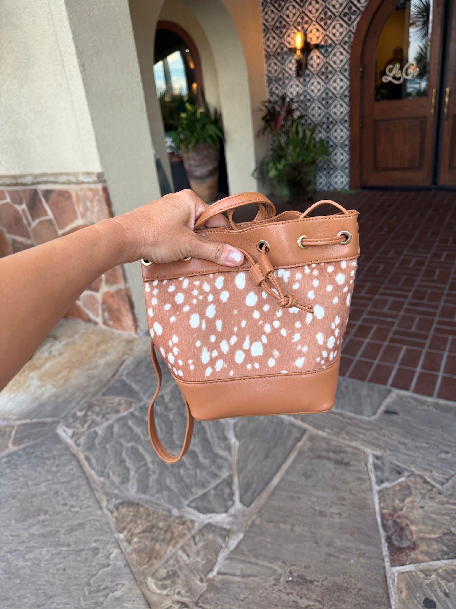 Okay, this little spotted bag is TOO cute!! 🤎 The tan color, white print, and drawstring details give it such a fun western feel. I love a bag that makes the whole outfit!

spotted handbag, western inspired bag, tan crossbody bag, drawstring bucket bag, animal print purse, fall handbag, brown handbag, statement bag, everyday crossbody, western accessories, fall fashion finds, JulieFranks