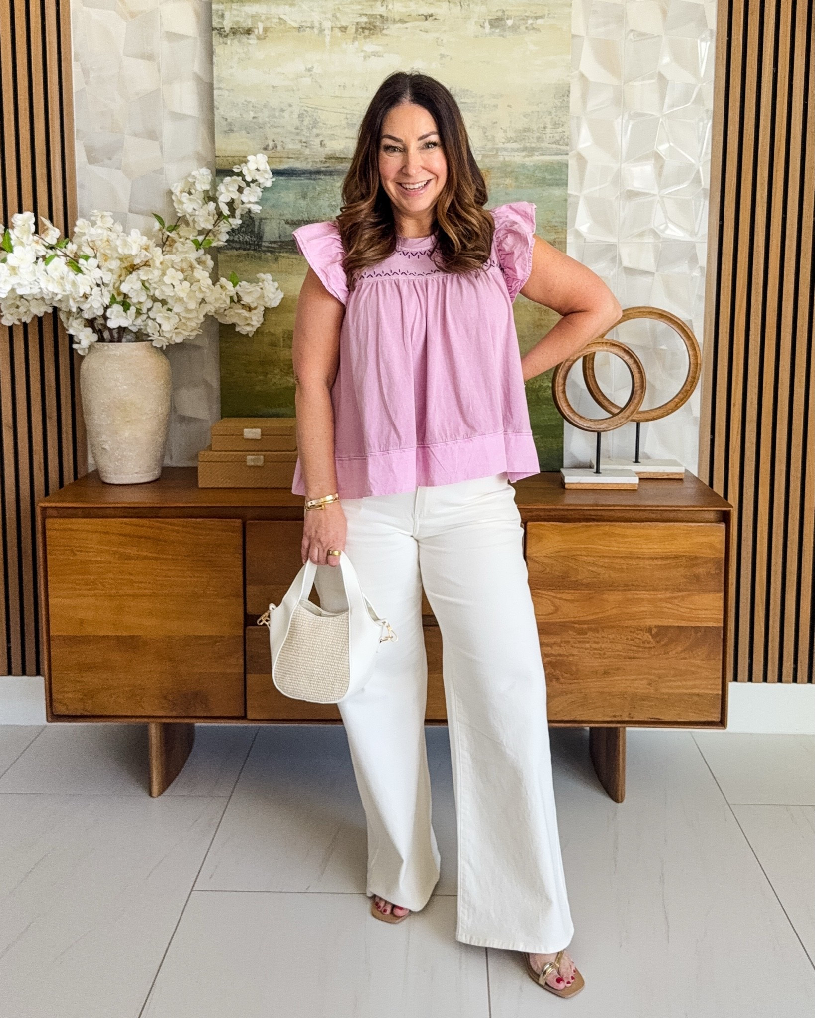 Spring vibes are calling and this lavender ruffle top is answering 🌸✨ This flutter sleeve babydoll top is giving all the feminine, breezy energy I need right now — and paired with wide leg white jeans and a woven mini bag? Chef's kiss. 🤍
This combo is so easy to dress up or down — brunch, errands, or a casual date night — it does it all!

👗 Sizing: Top: wearing a Large (size up if in-between!) Pants: wearing 32R

#LTKStyleTip #LTKFindsUnder100 #SpringOutfit #SpringStyle #WideJeans #RuffleTop #OOTD #LTKover40 #Midsize

#LTKmomlife #LTKOver40